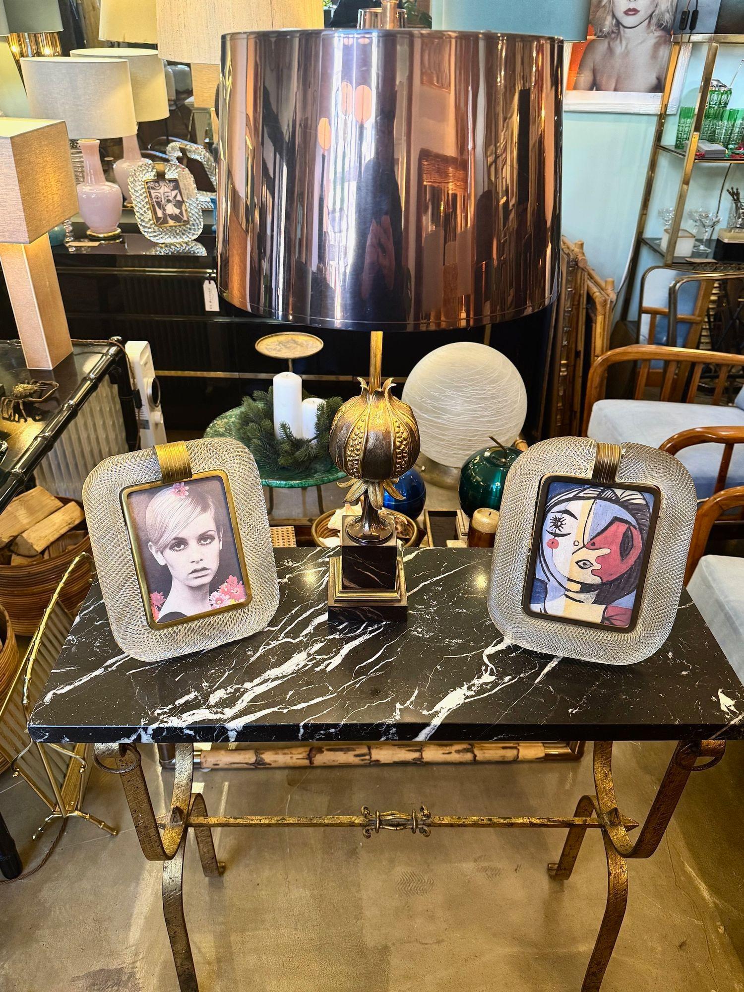 A Spanish 1950s wrought iron gilt console table with black and white Nero Marquina marble top. The wrought iron base has hammered legs with hanging corner rings detail.