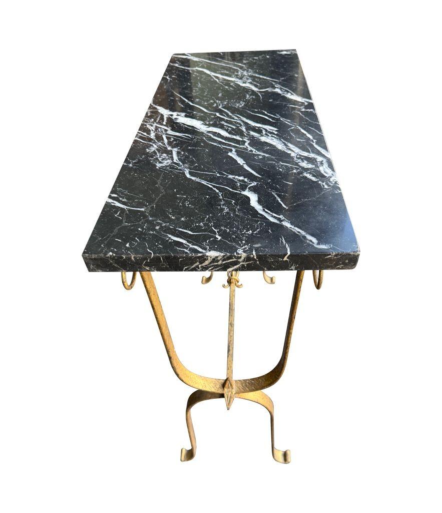 Mid-20th Century A Spanish 1950s wrought iron gilt console table with Nero Marquina marble top For Sale