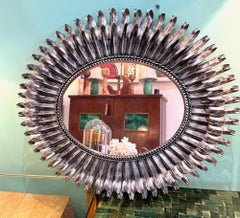 A Spanish 1960s silvered metal oval portrait or landscape eyelash mirror