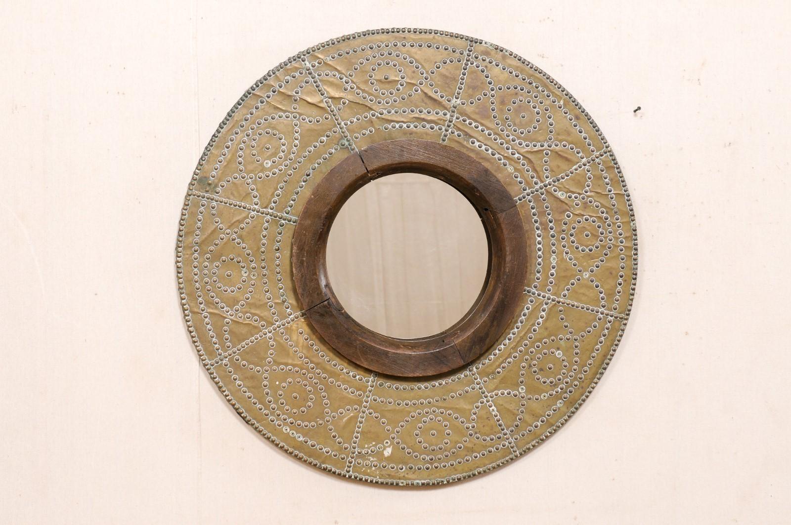 This beautiful round mirror has been custom fashioned from a Spanish 19th century copper brazier. This Spanish wall decoration features a round copper wrapped (over wood) 