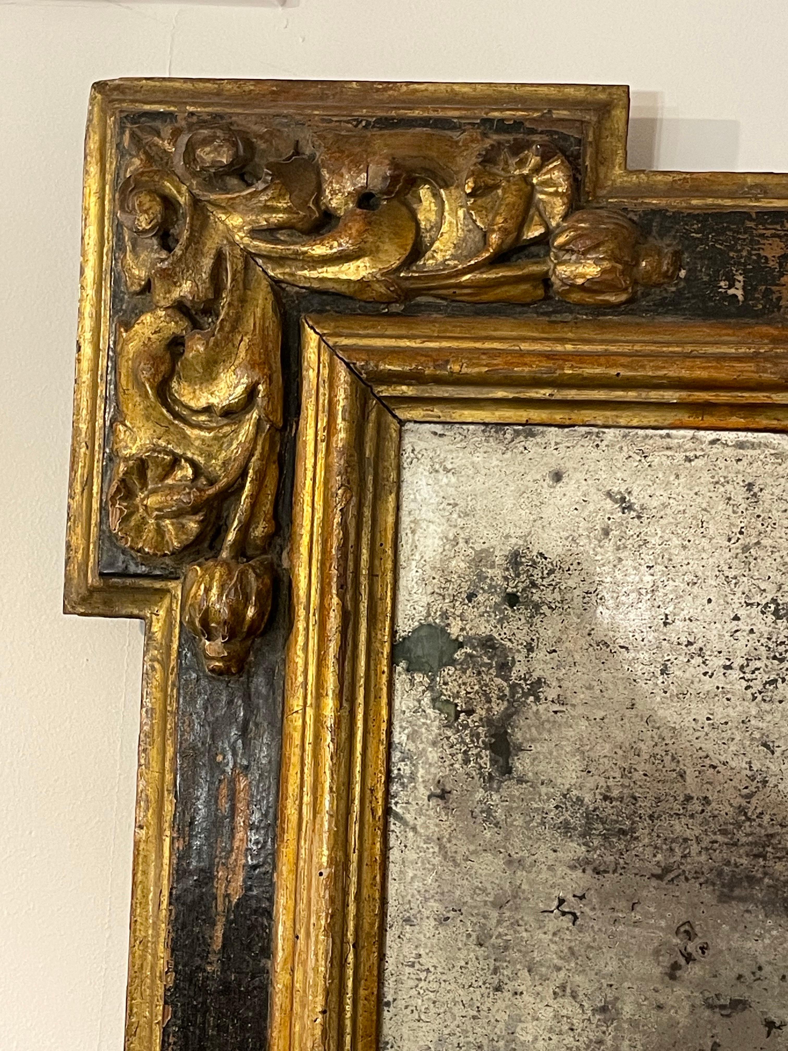 A Spanish Gilded Mirror, 18th Century

Provenance:  
Private Old Melbourne Collection.

Description:
The plate encased by gilded fillets to ebonised primary frame, the outline of each corner stepped and mounted with applied foliate and floret