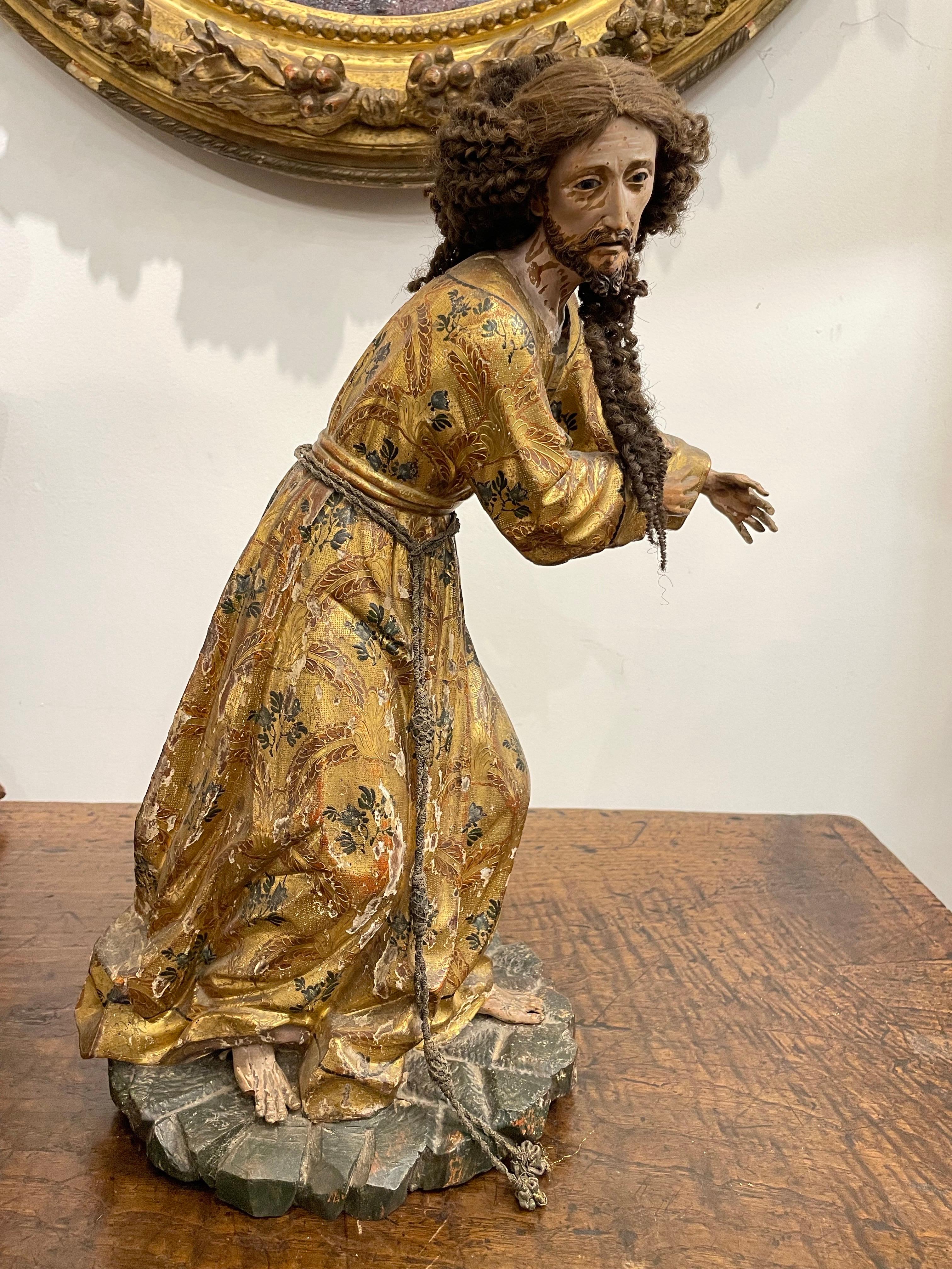 A Spanish Giltwood Polychrome Decorated Figure of a Saint, Early 19th Century 

Provenance: Private American Collection.

Description: 
Depicted with a full head of curly hair and standing with both arms reaching towards his right, dressed in an