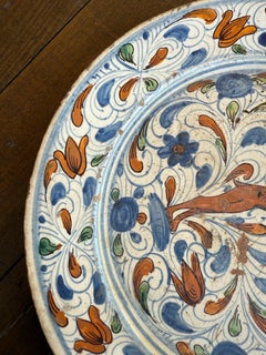 A Spanish Polychrome Earthenware Plate, 18th Century