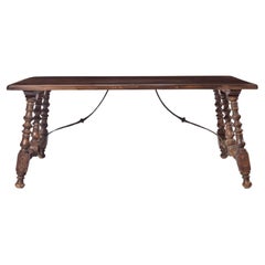 A Spanish Style Stained-Fruitwood Trestle Table, 20th Century