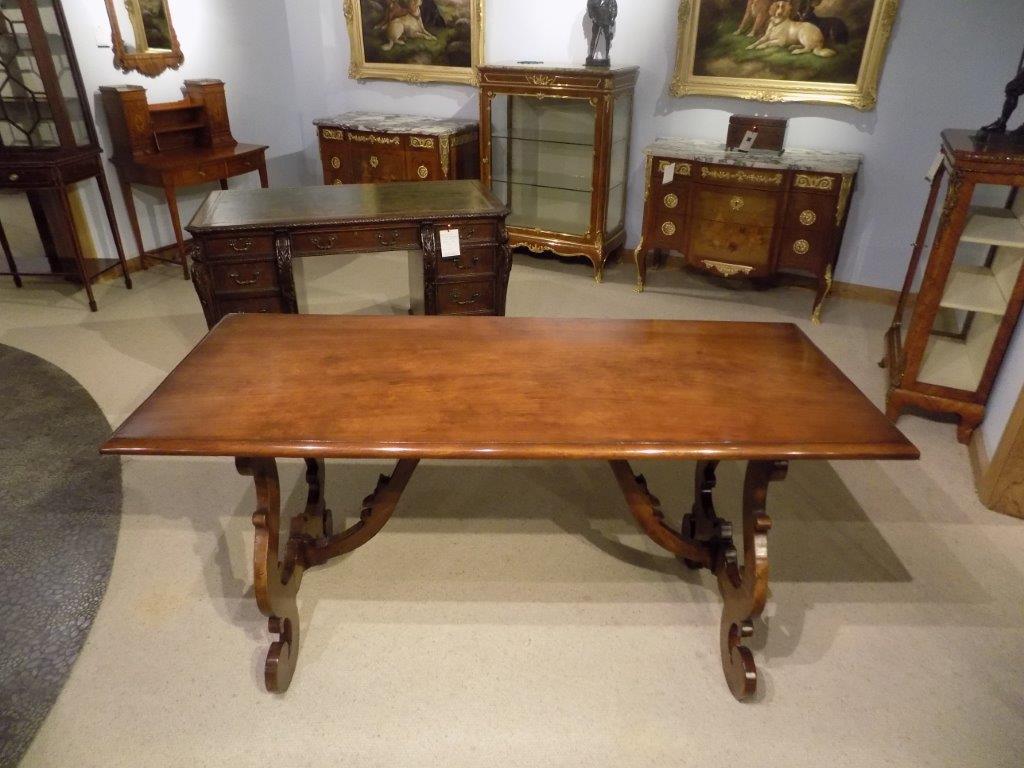 A Spanish style walnut Antique refectory dining table. The rectangular solid walnut top supported on shaped walnut 