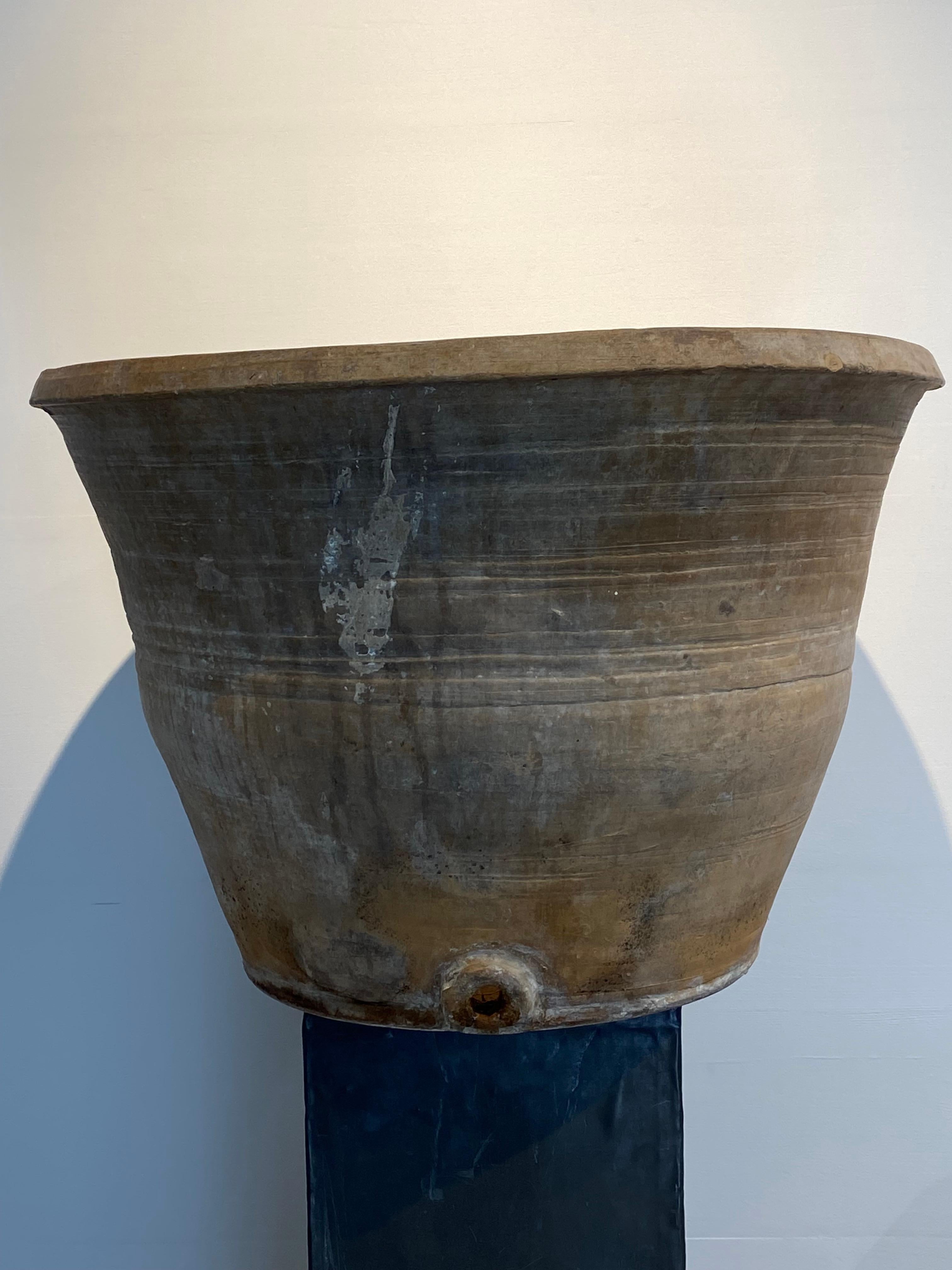 Exceptional Antique Spanish Terracotta Pot used for producing Olive oil,
the pot has an exceptional beautiful old patina and shine,
there is also an opening for releasing the liquids,
powerful object,to be used for different purposes