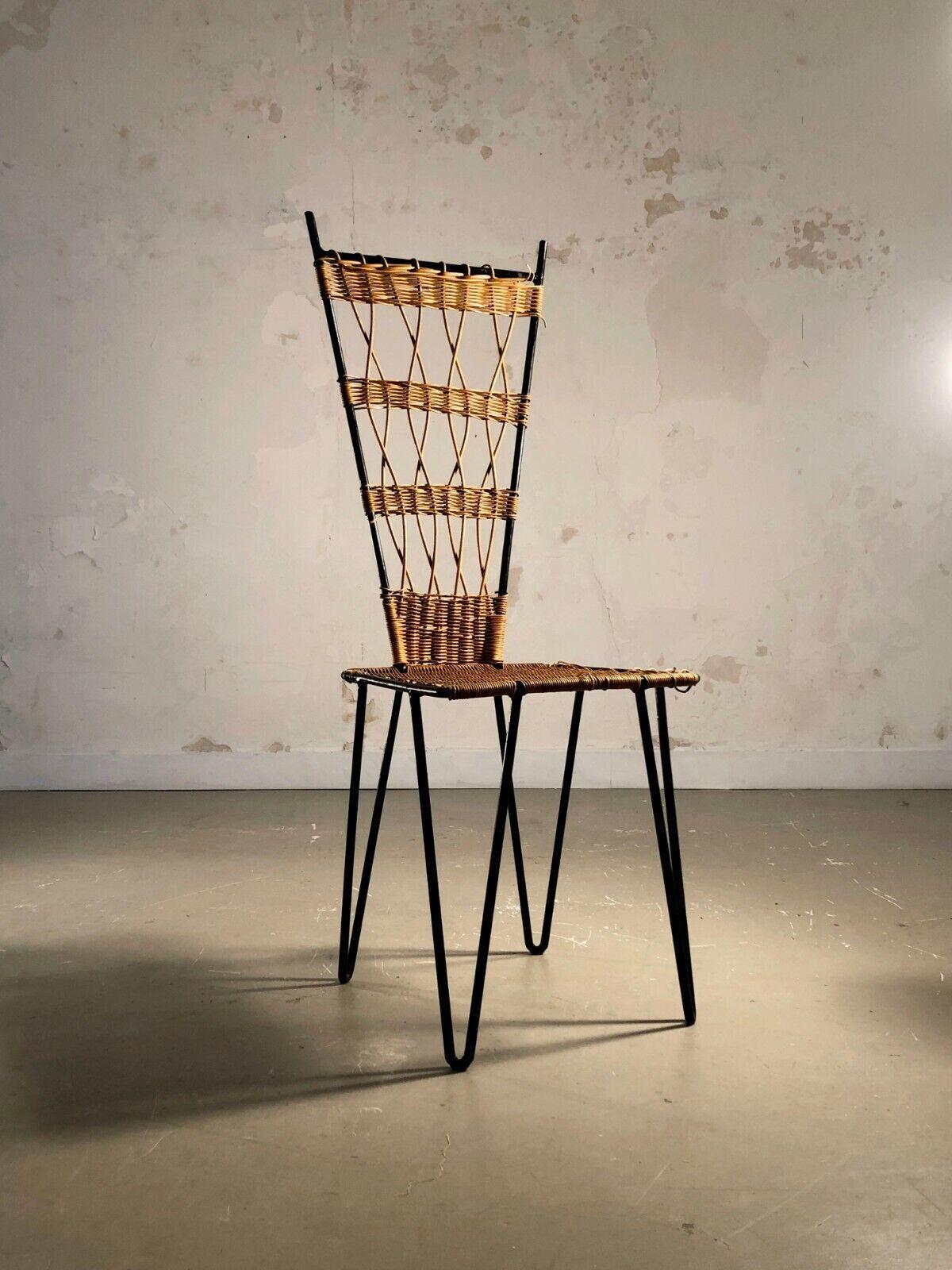 A spectacular chair of tribal inspiration, Modernist, Brutalist, Popular Art, Free Form, black lacquered metal structure, seat and back with graphic openwork rattan decorations, by Raoul Guys, France 1950-1960.
