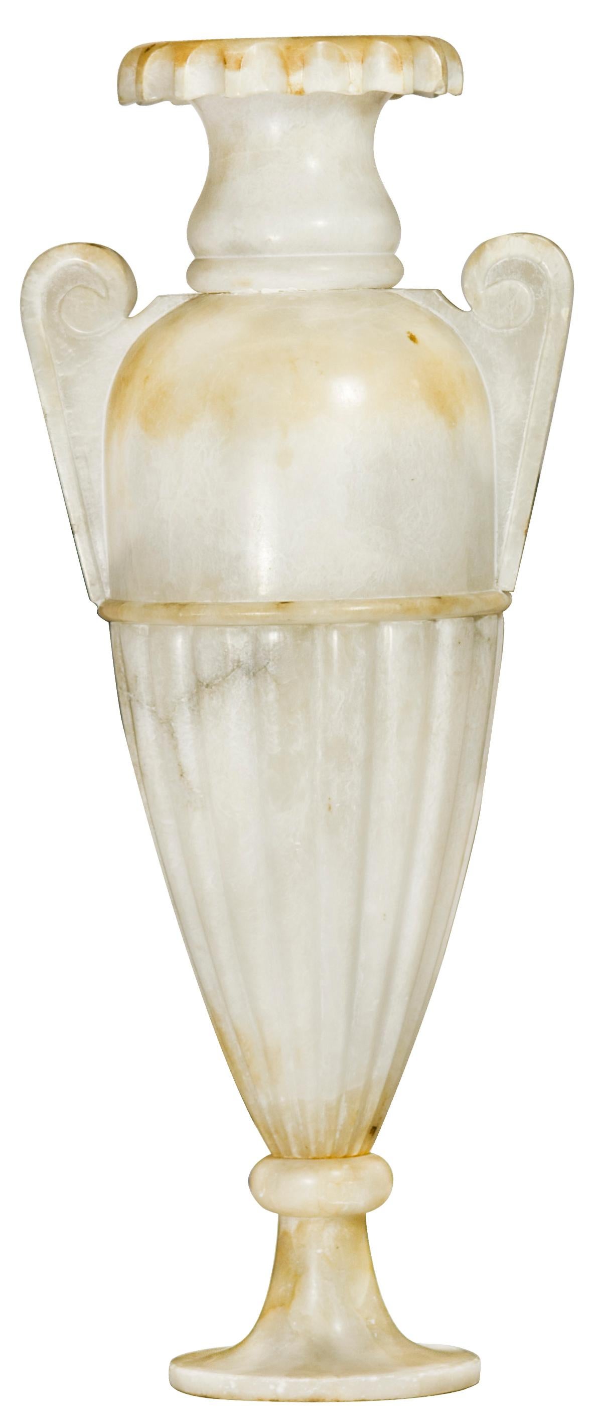 A large neoclassical style alabaster amphora lamp, featuring interior light source.