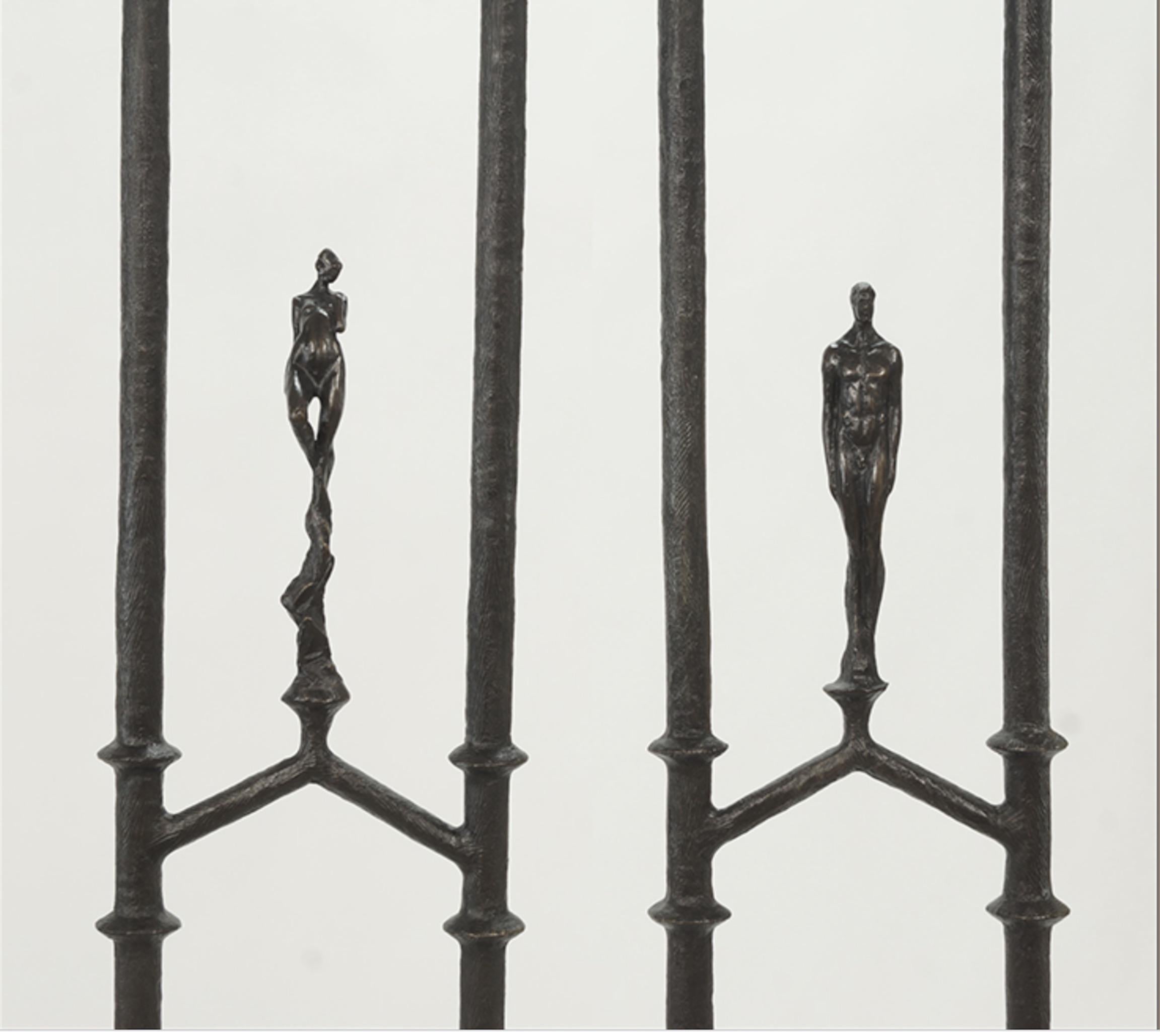 A spectacular pair of Tom Corbin bronze floor lamps with a male or female figure at the center of each. Bases are signed 