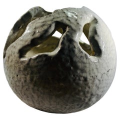 A spherical white ceramic cachepot with cracked enamel France XXth century