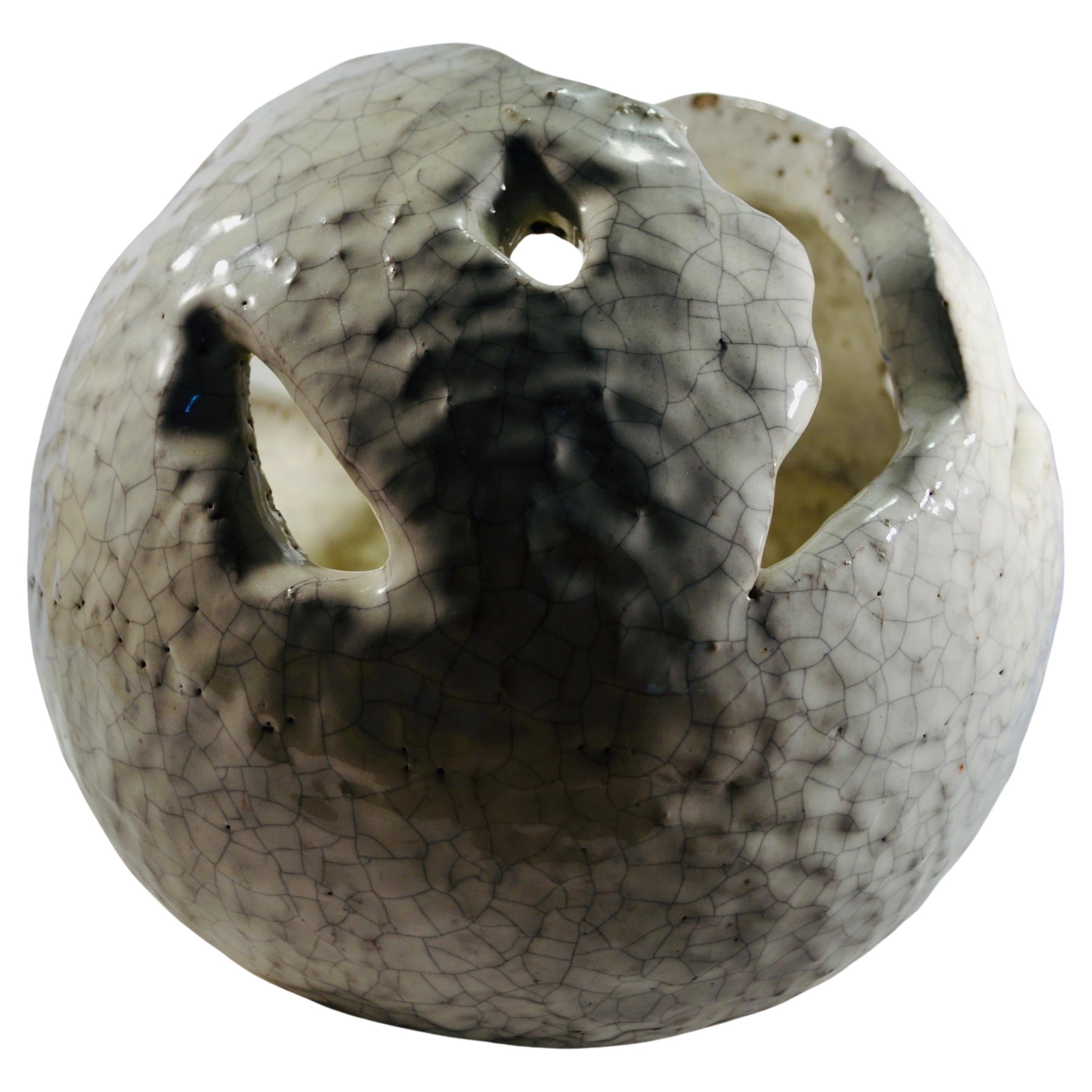 A spherical white ceramic cachepot with cracked enamel France XXth century For Sale