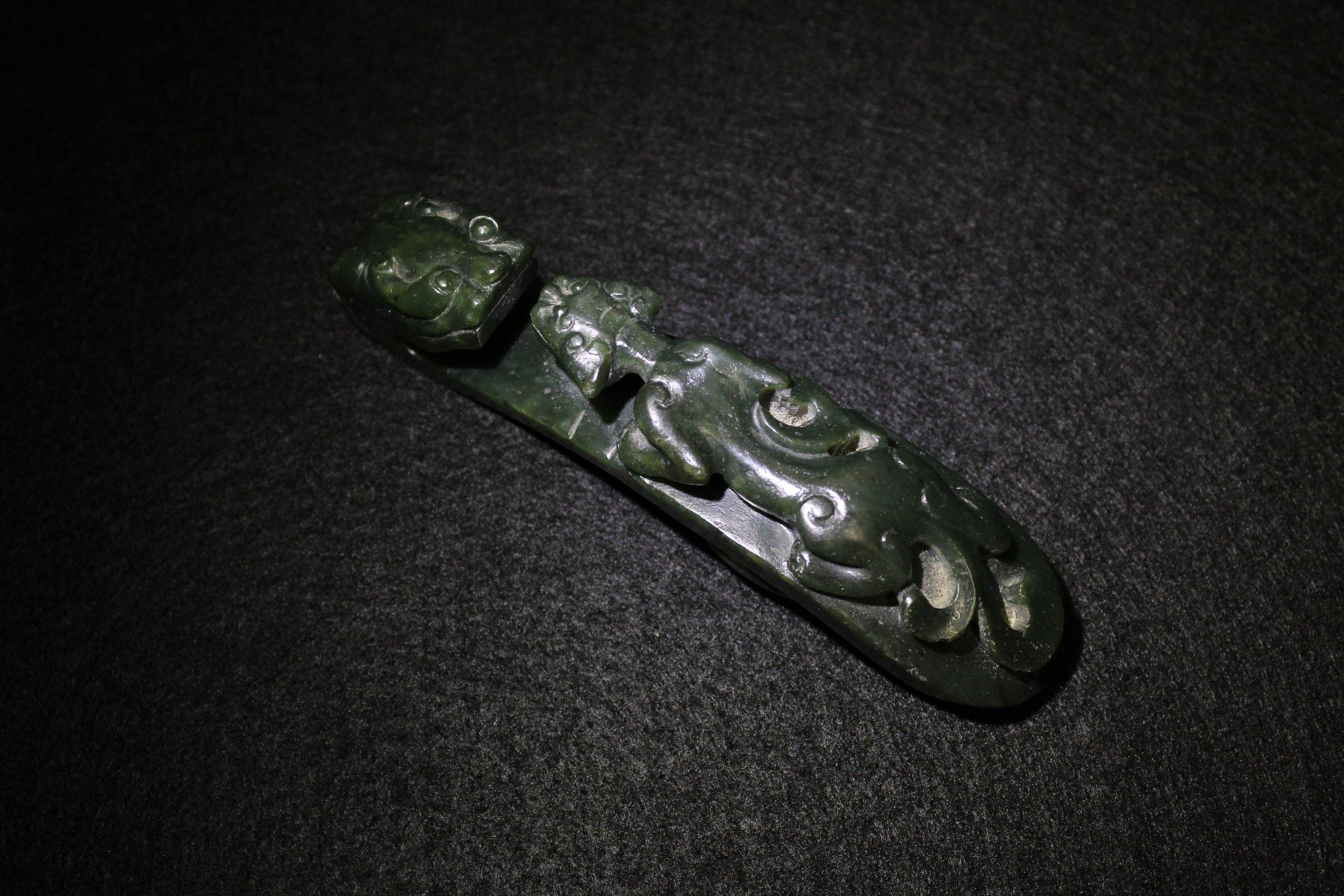 A Spinach-Green Jade 'Chilong' Belt Hook, Qing Dynasty 1