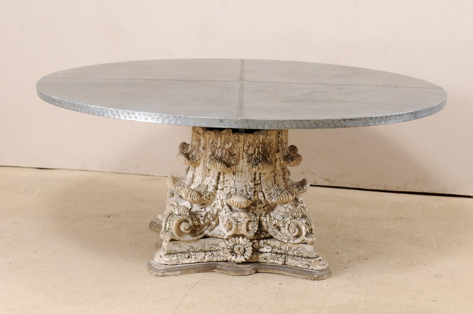 A custom zinc top and early 20th century capital base dining table. This fabulous custom table has been fashioned from the base of an antique American plaster and terracotta column, heavily adorn in acanthus leaf motif, topped with the addition of a