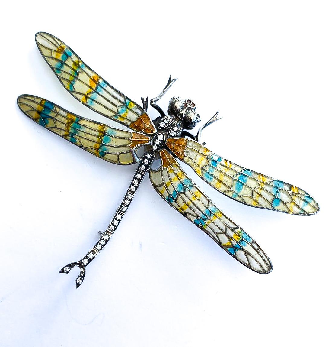 A beautiful plique a jour and sterling 'dragonfly' brooch, carefully created and designed. Probably made in the late 20th century,  from resin (the plique a jour) , clear paste, all set in sterling silver , and maker unknown, it is beautifully