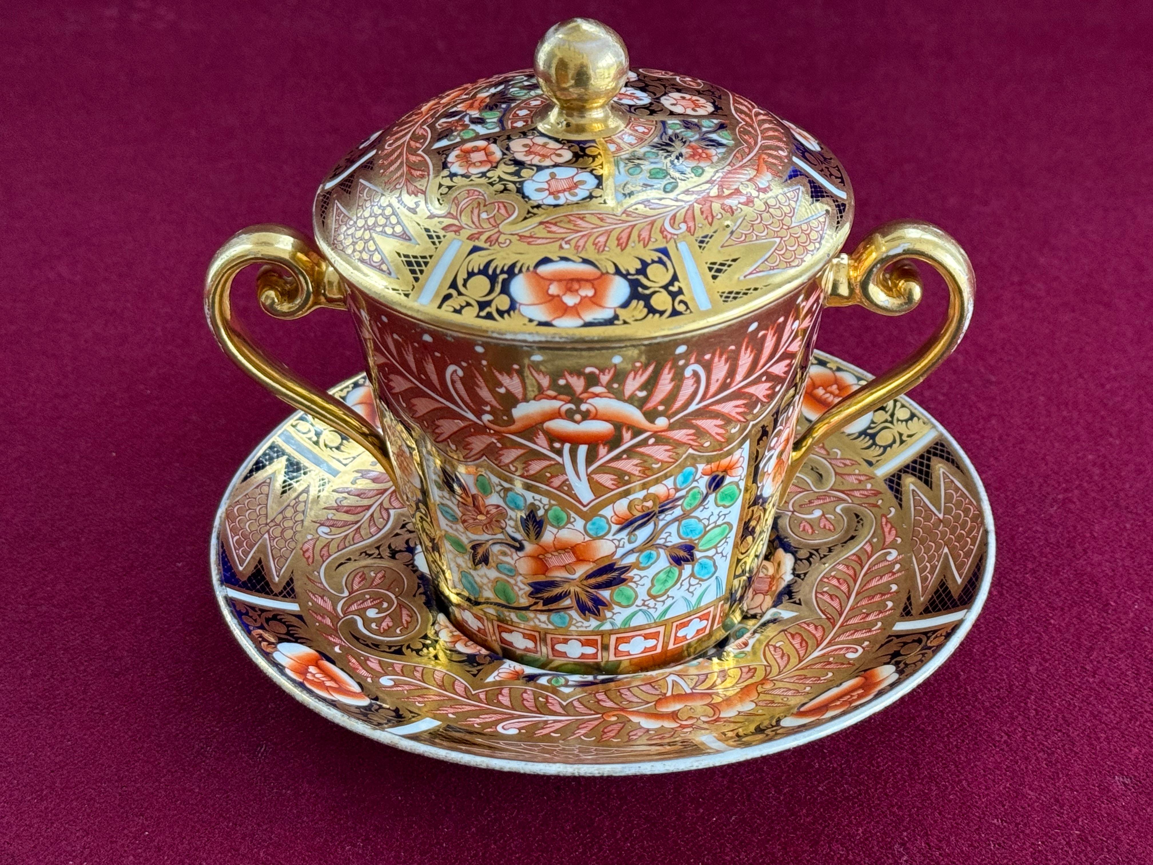 A very fine Spode bone china chocolate cup, cover and stand, vibrantly decorated in pattern 1494 which is an extremely ornate Imari design which covers every inch of the piece. This pattern was introduced c.1809 and was probably a direct copy of a