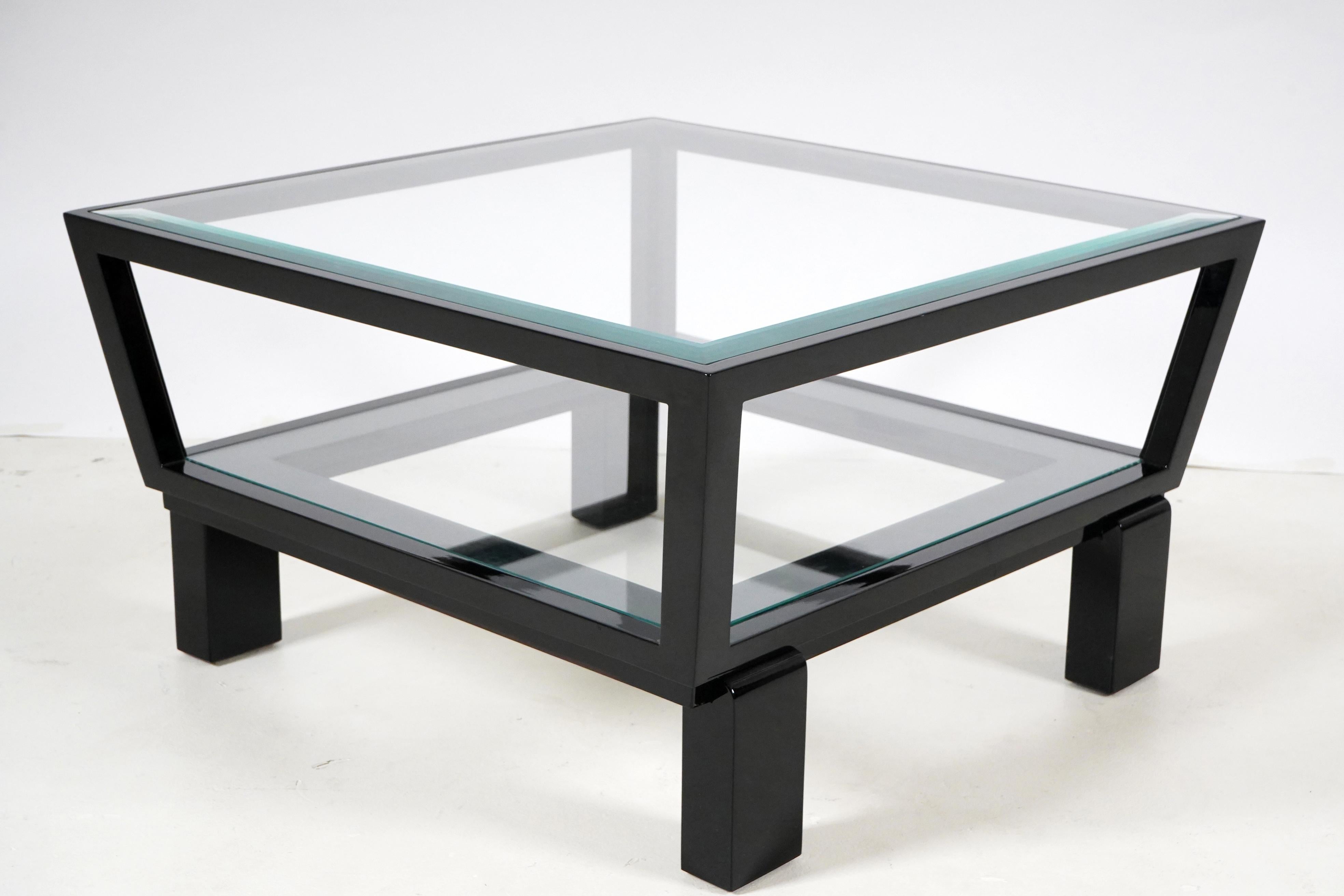 This simple wood and glass coffee table was inspired by a Hungarian Art Deco design from Budapest. The solid walnut frame holds two glass shelves and has been given a very dark coat of French polish. In the 1920's and 30's, many bold furniture