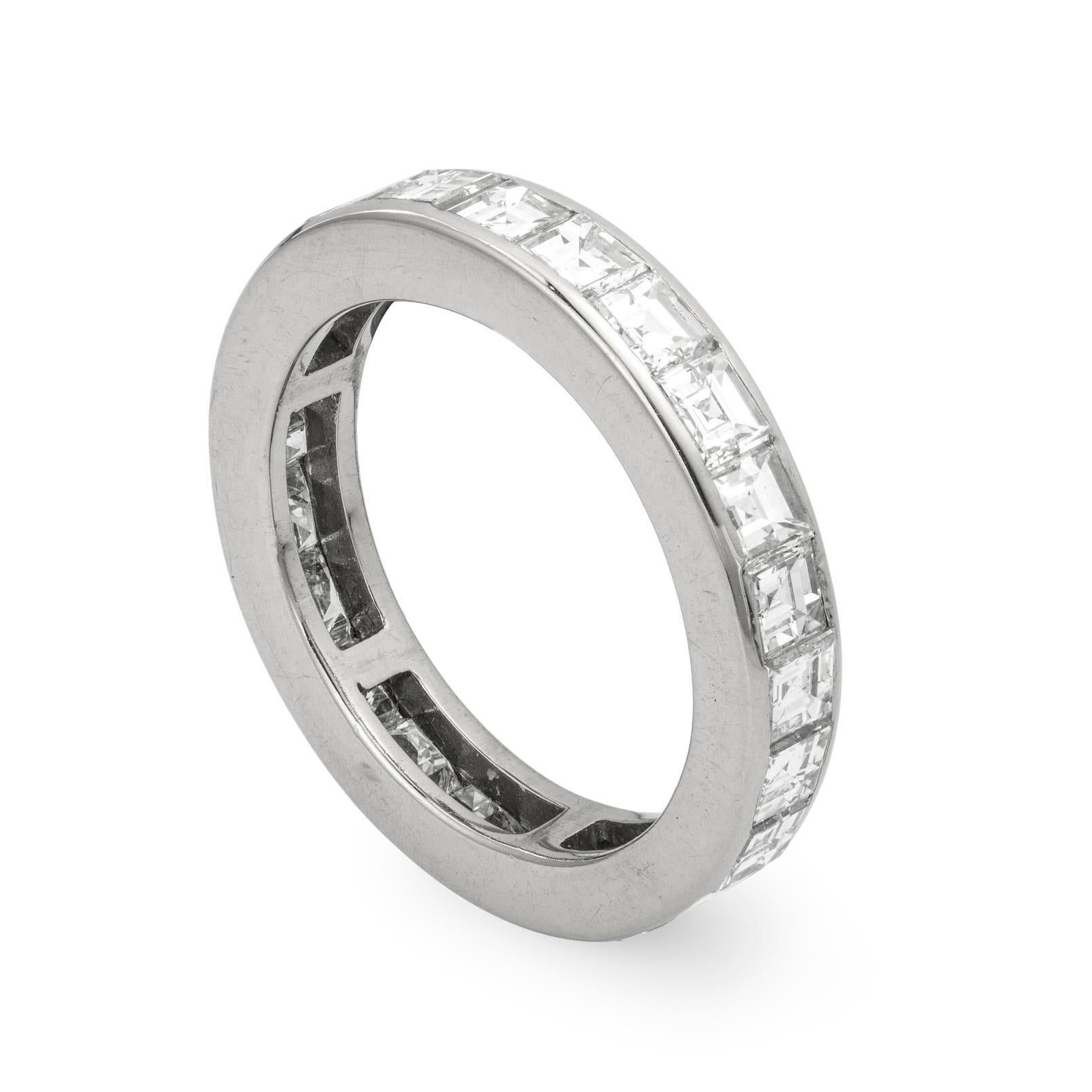 A square-cut diamond set full eternity ring, the twenty four square-cut diamonds weighing an estimated total of 3.6 carats, channel set to a 4mm wide white mount, later hallmarked 18ct gold, London 2016,  finger size M, gross weight 5 grams.  

This