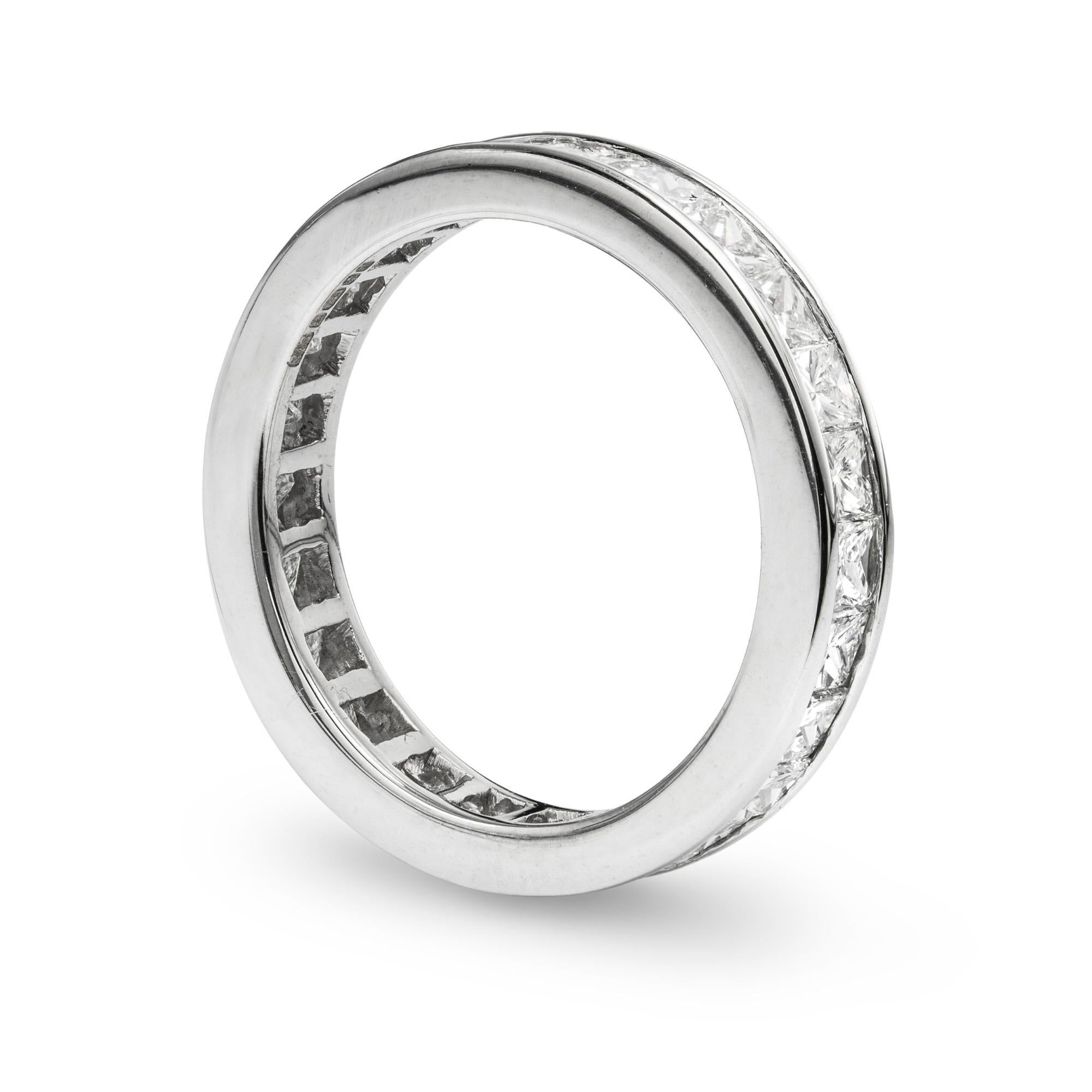 A square-cut diamond set full eternity ring, the twenty four square-cut diamonds weighing an estimated total of 2.5 carats, assessed colour G-H, assessed clarity VS1-2, channel set to a 4mm wide white mount, later hallmarked 18ct gold, London 2016, 