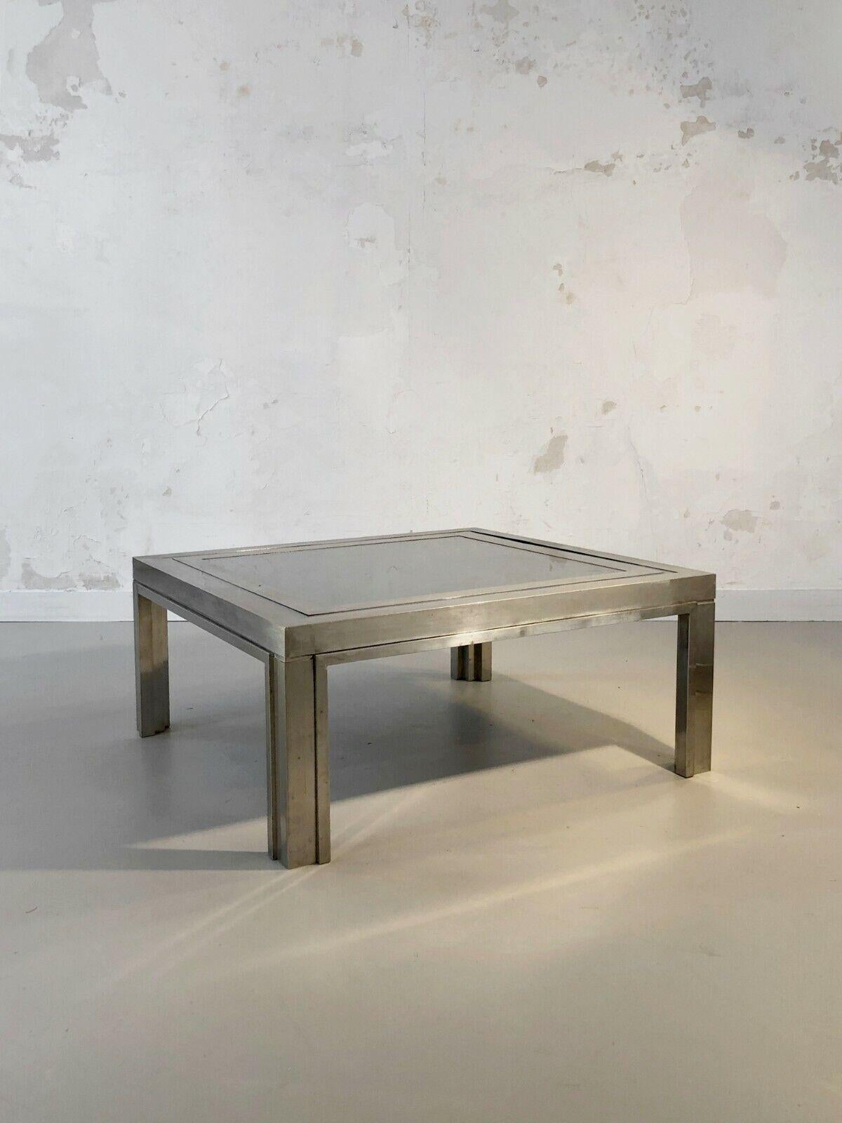 A rigorous and powerful square coffee table, Post-Modernist, Kinetic, Constructivist, Shabby-Chic, complex constructivist structure with geometric reliefs in wood veneered with bronze or nickel-plated brass, double-frame top, nickel-plated frame on