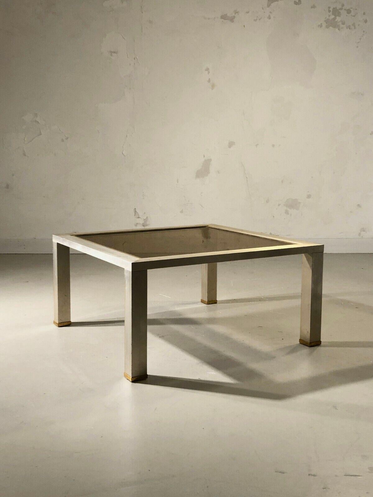 An elegant and rigorous square coffee table, Post-Modernist, Bauhaus, Shabby-Chic, Space-Age, structure in square section aluminum slats with a matt metal gray appearance with a light varnish , smoked glass top enhanced by a gilded brass frame,