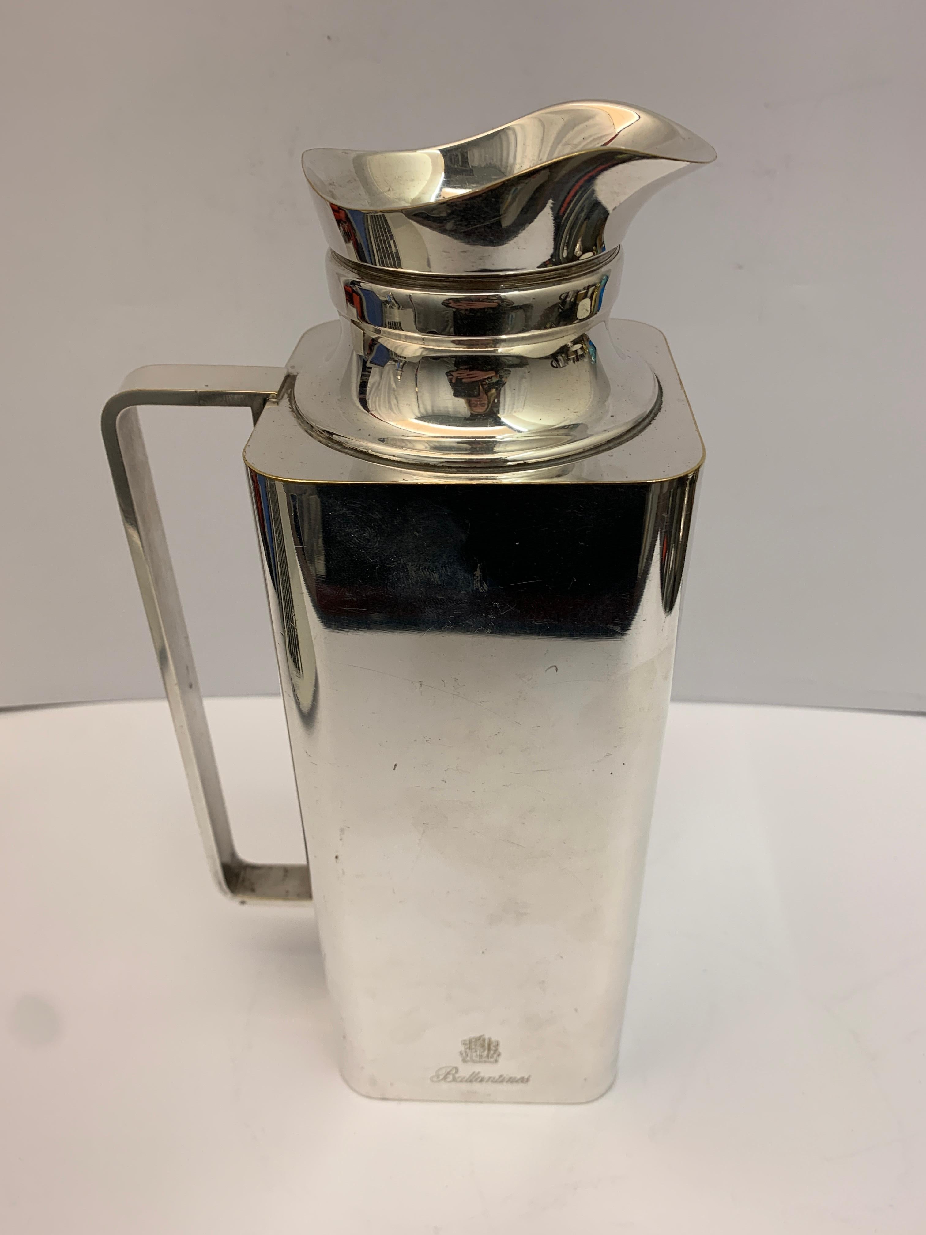 A large square silver plated thermos with lid, with the Ballentines logo and crest.