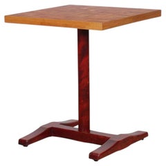 A square-topped dining table made of solid wood, dating from the 1980s