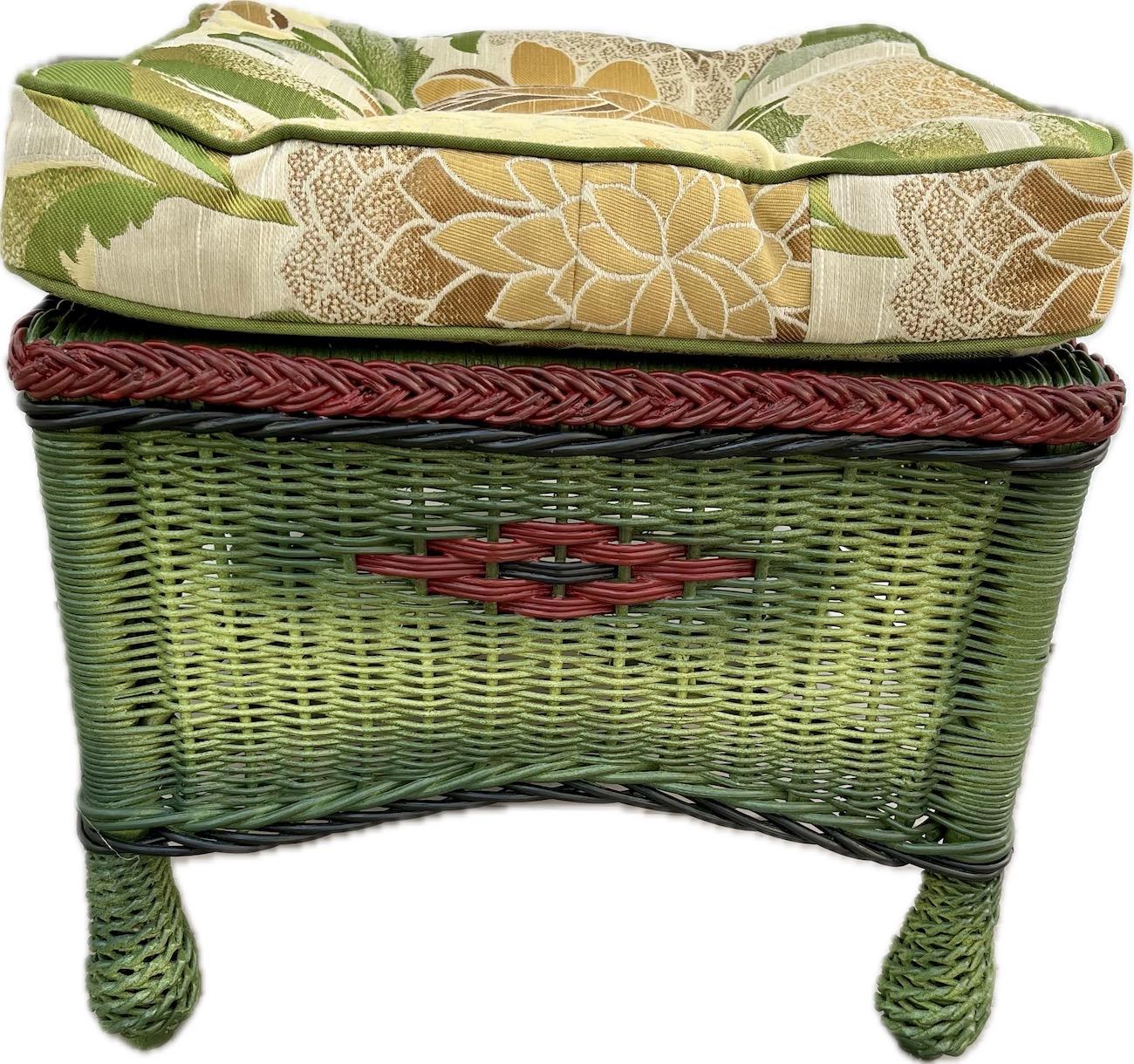 A fairly rare and unique wicker ottoman made by the Heywood Wakefield Company Gardner,Ma. C.1920. This handsome wicker ottoman is made with a closely woven reed design in a shaded French green finish with black and red trimming, It is fully skirted