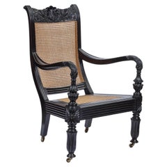 A Sri Lankan ebony and cane ‘Easy chair’ or 'planter's chair'