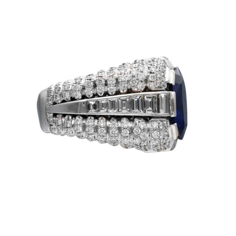 Centering an oval sapphire, accented by 196 round diamonds and 20 baguette-shaped diamonds.
 - Sapphire weighs 6.09 carats
 - Diamond weighing a total of approximately 4.00 carats
 - Size 7 
- Total weight 23.66 grams
 - 18 karat white gold
 -