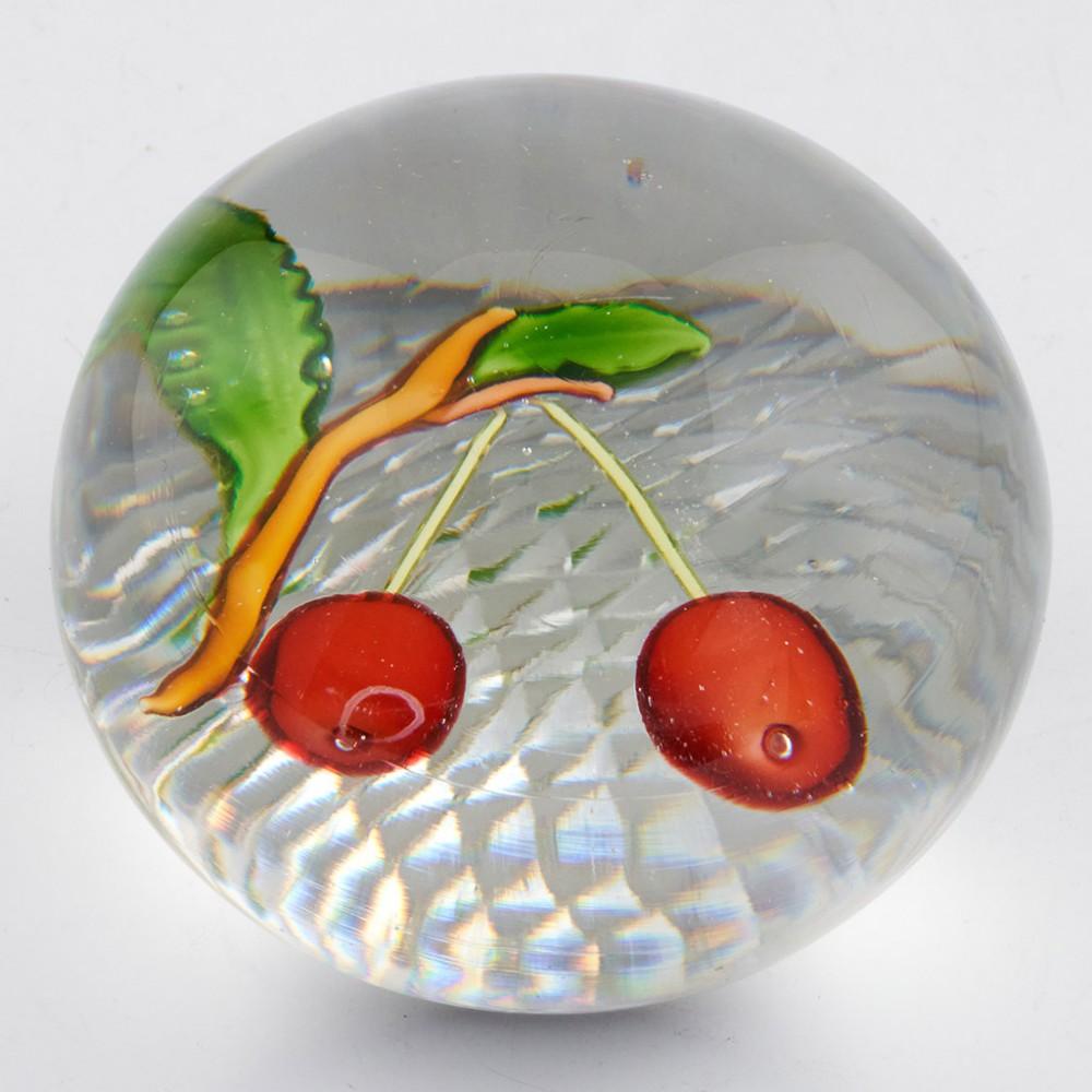 A St Louis Two Cherry Paperweight, c1850

Additional information:
Date : c1850
Origin : St Louis, France
Features : Two cherries, two leaves and branch on a clear ground with strawberry cut base
Marks : None
Type : Lead
Size : Diameter 7.6