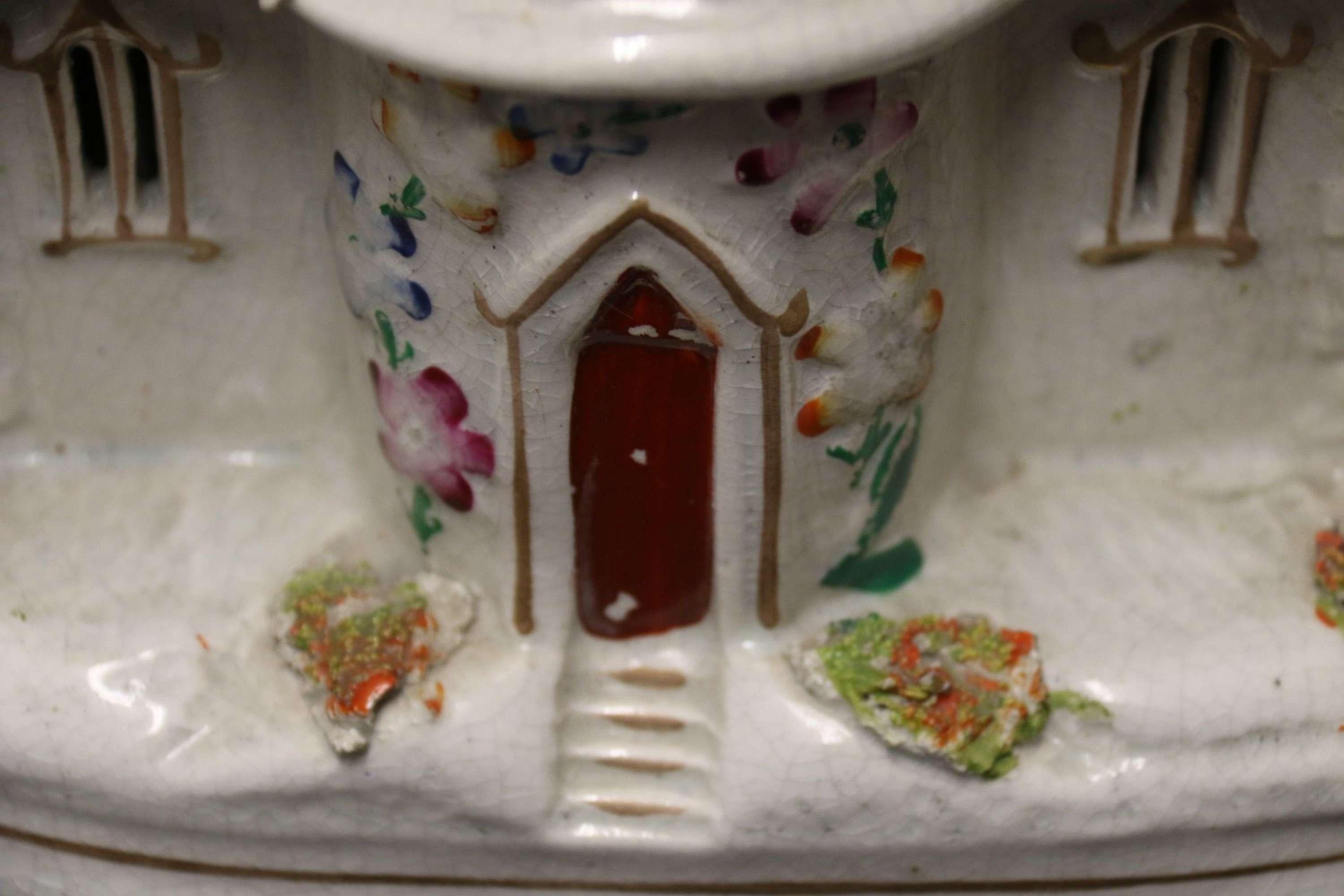 A Staffordshire Pottery Model of an English Cottage

This larger sized Staffordshire pottery model of an English country estate folly type of cottage is of a most unusual design. The centre is circular and three-storey with a rectangular wing to
