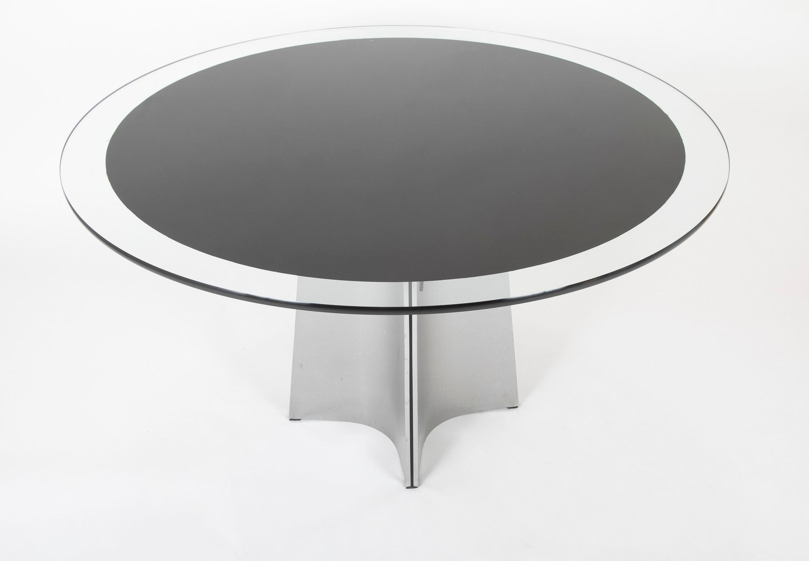 A round back painted glass dining table with stainless steel base. Designed by Maison Jansen, unmarked.