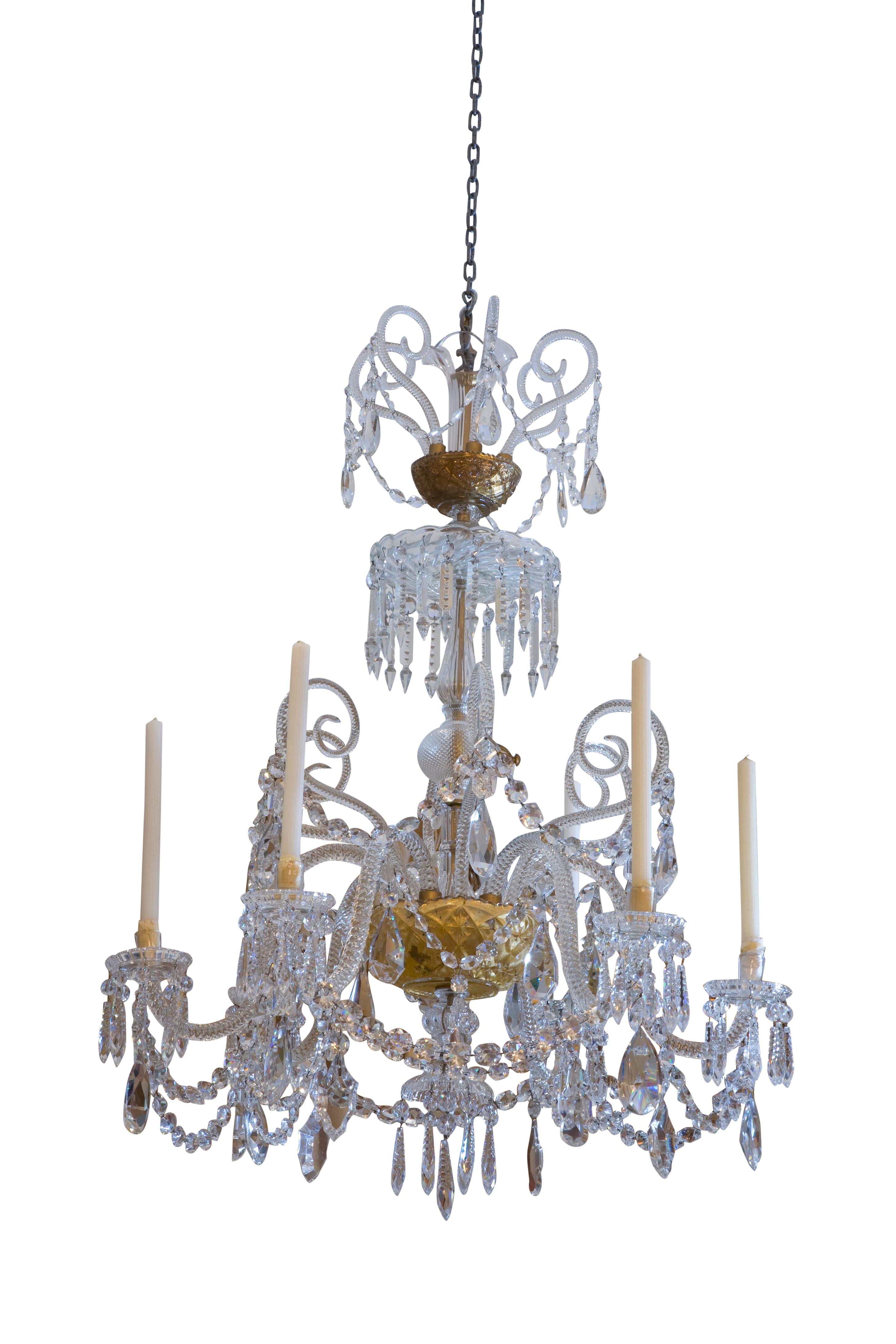 A rope-twist crystal six-arm chandelier, on three tiers, the arms and additional decorative elements stem from an interior decorated gilded glass bowl; the bobesches are stamped Baccarat, all the hanging crystals are cut and faceted in the manner