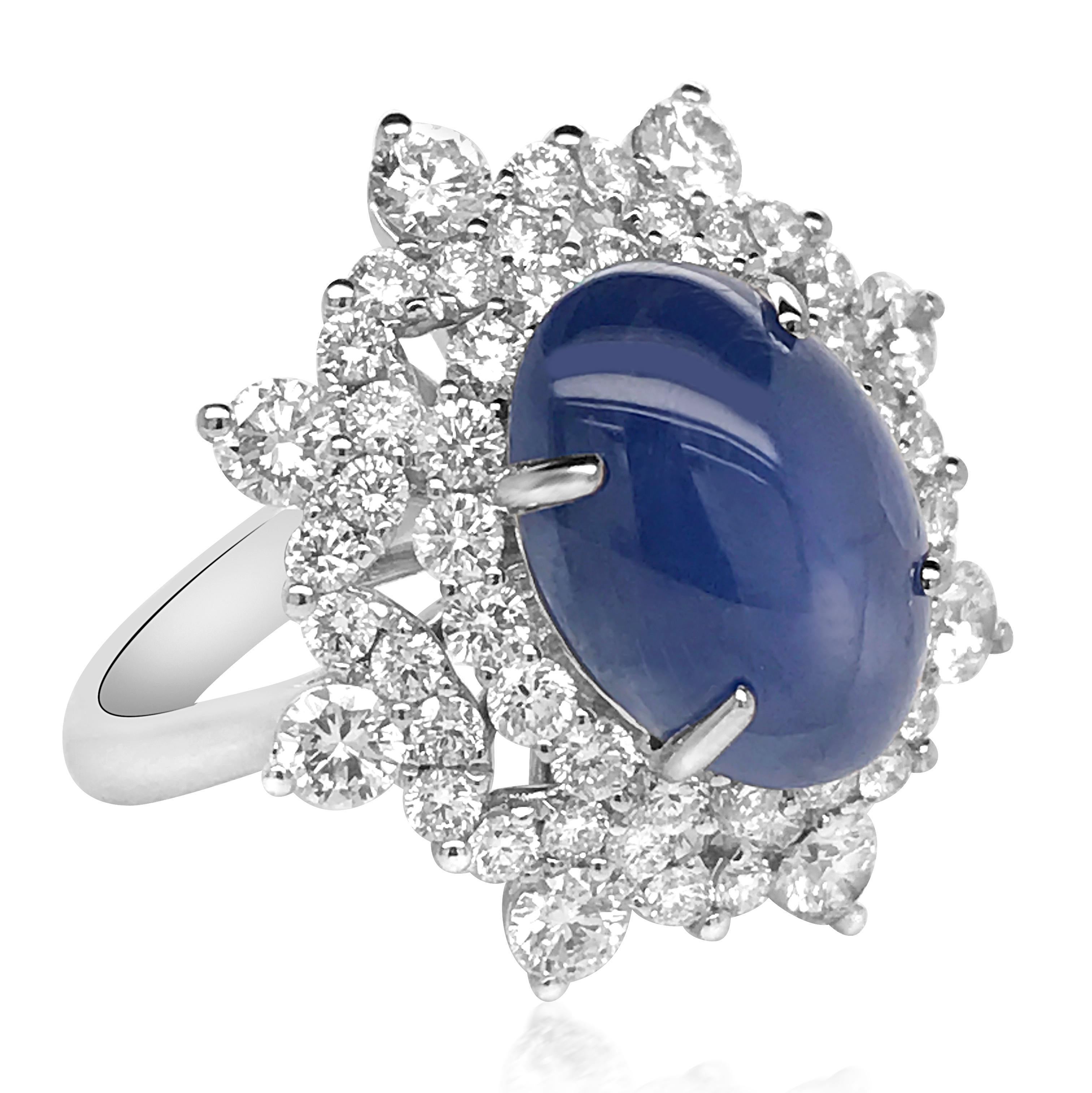 This stunning Burma natural blue sapphire and diamond ring is crafted in 18K white gold, featuring a star sapphire weighing 5.11 carats; surrounded by 58 round brilliant-cut diamonds weighing a total of 1.83 carats, most with E-F color and VS-SI