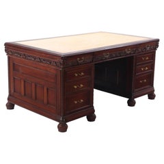 A stately American Victorian carved mahogany three-part pedestal writing desk, C