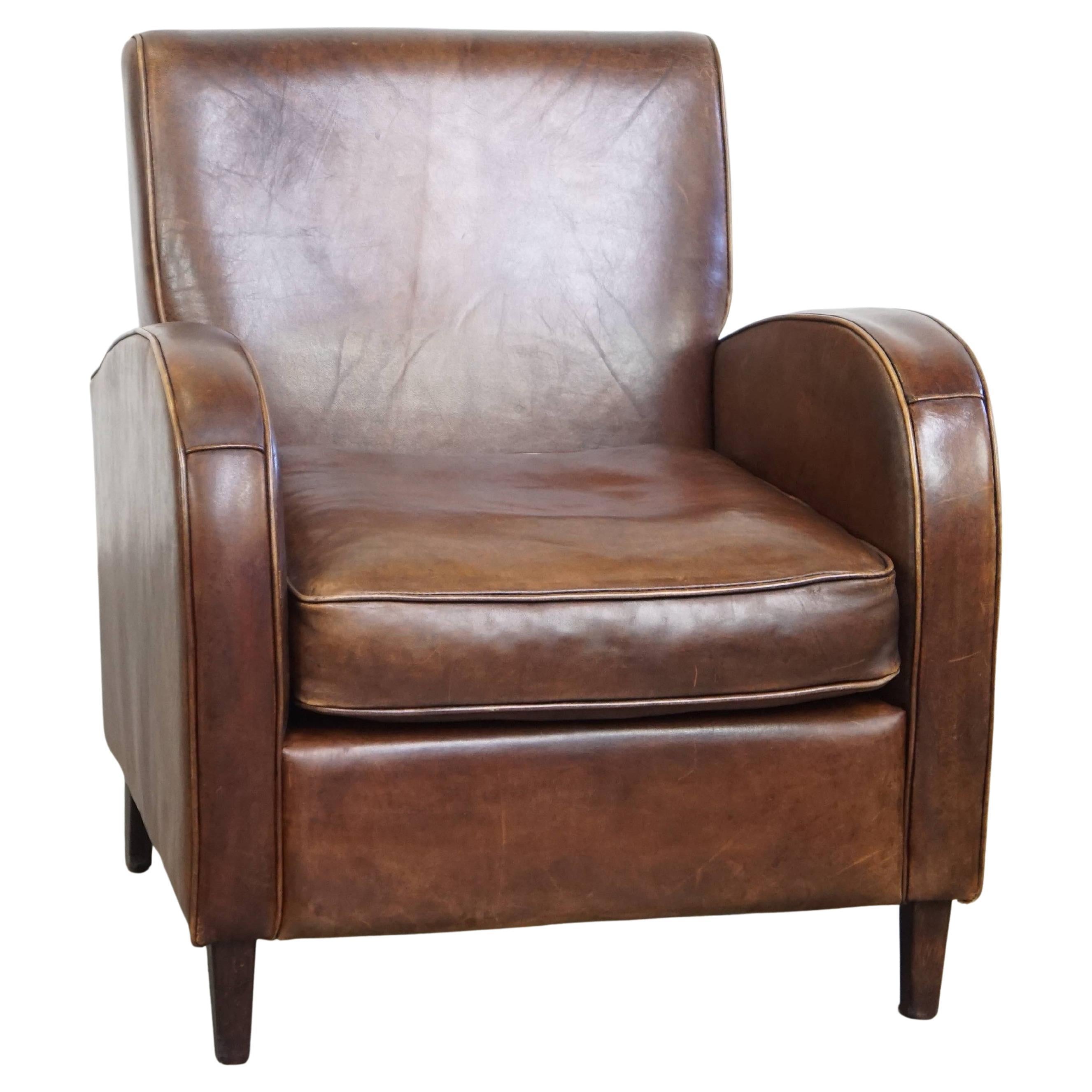 A stately, well-preserved, and comfortable sheepskin armchair, beautiful patina