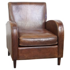 A stately, well-preserved, and comfortable sheepskin armchair, beautiful patina