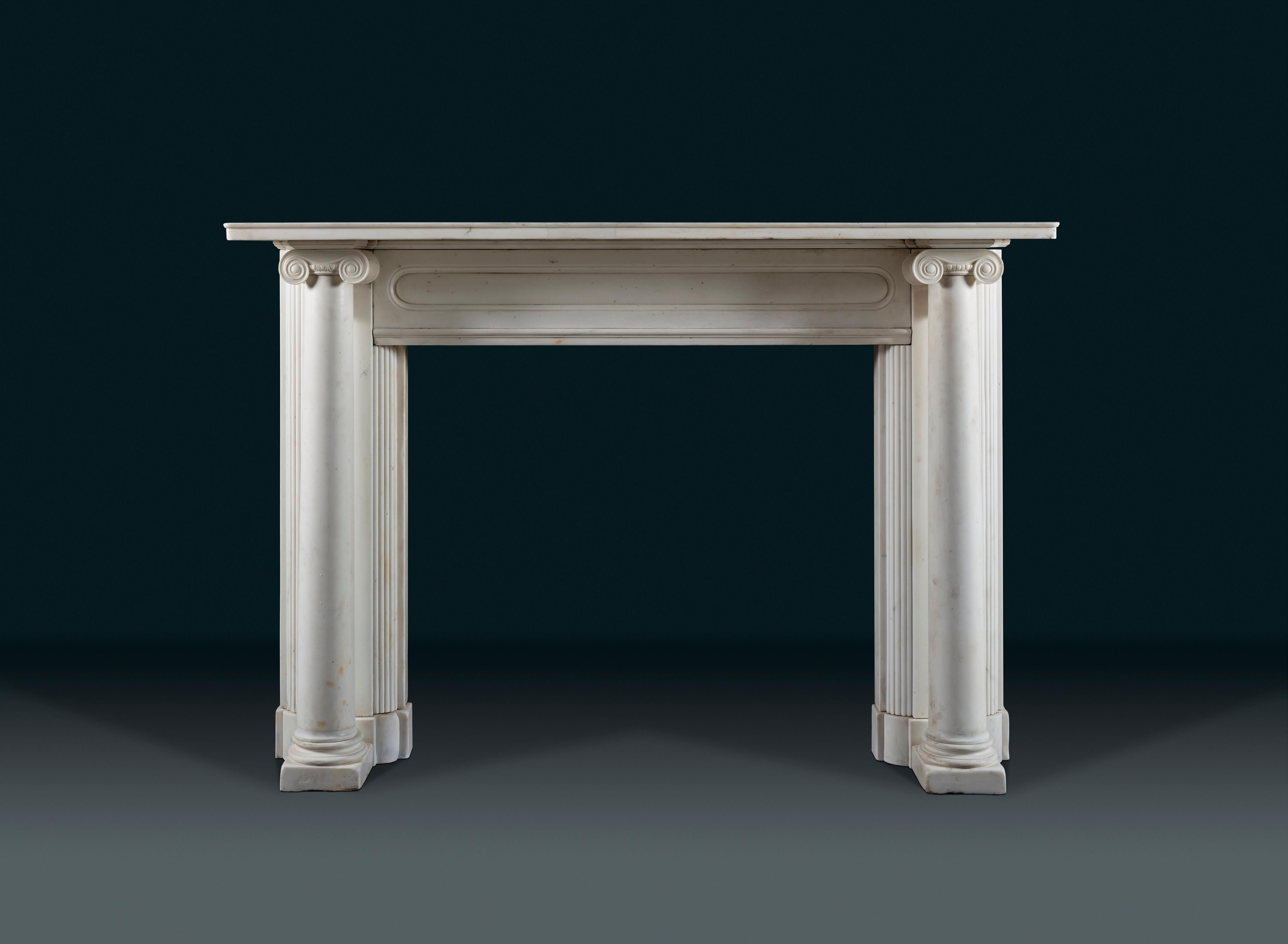 A characterful statuary marble fireplace after Sir John Soane. The shelf resting directly on the Ionic capitals of the columns make this a very architectural piece. The use of detached columns as jambs was firstly seen in the Early Renaissance, and