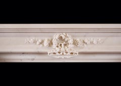 A Statuary White Marble Fireplace in the Louis XVI Style.