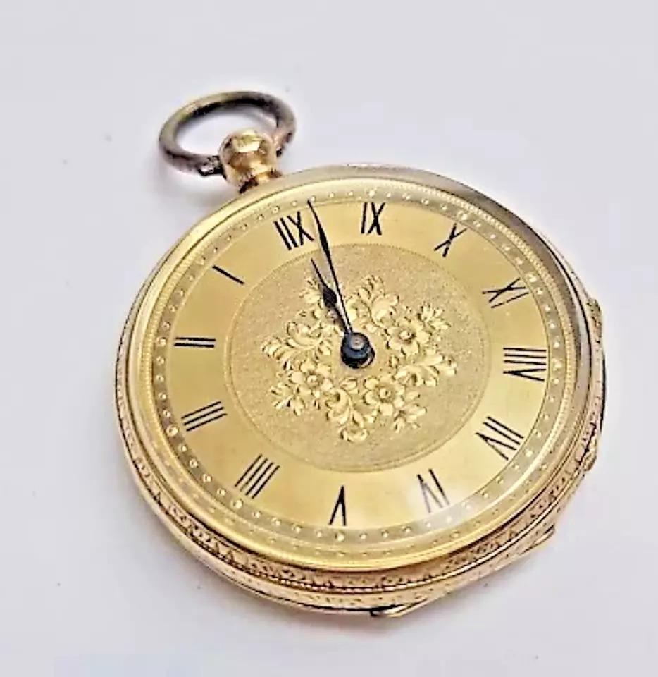 A Stauffer Cx. de Fond precious yellow metal 18ct Solid Gold ladies' pocket watch, 
key wind, having polished and engine turned gold Roman numeral dial, 36.5mm wide floral engraved yellow metal case (yellow metal assessed as 18ct. gold), movement