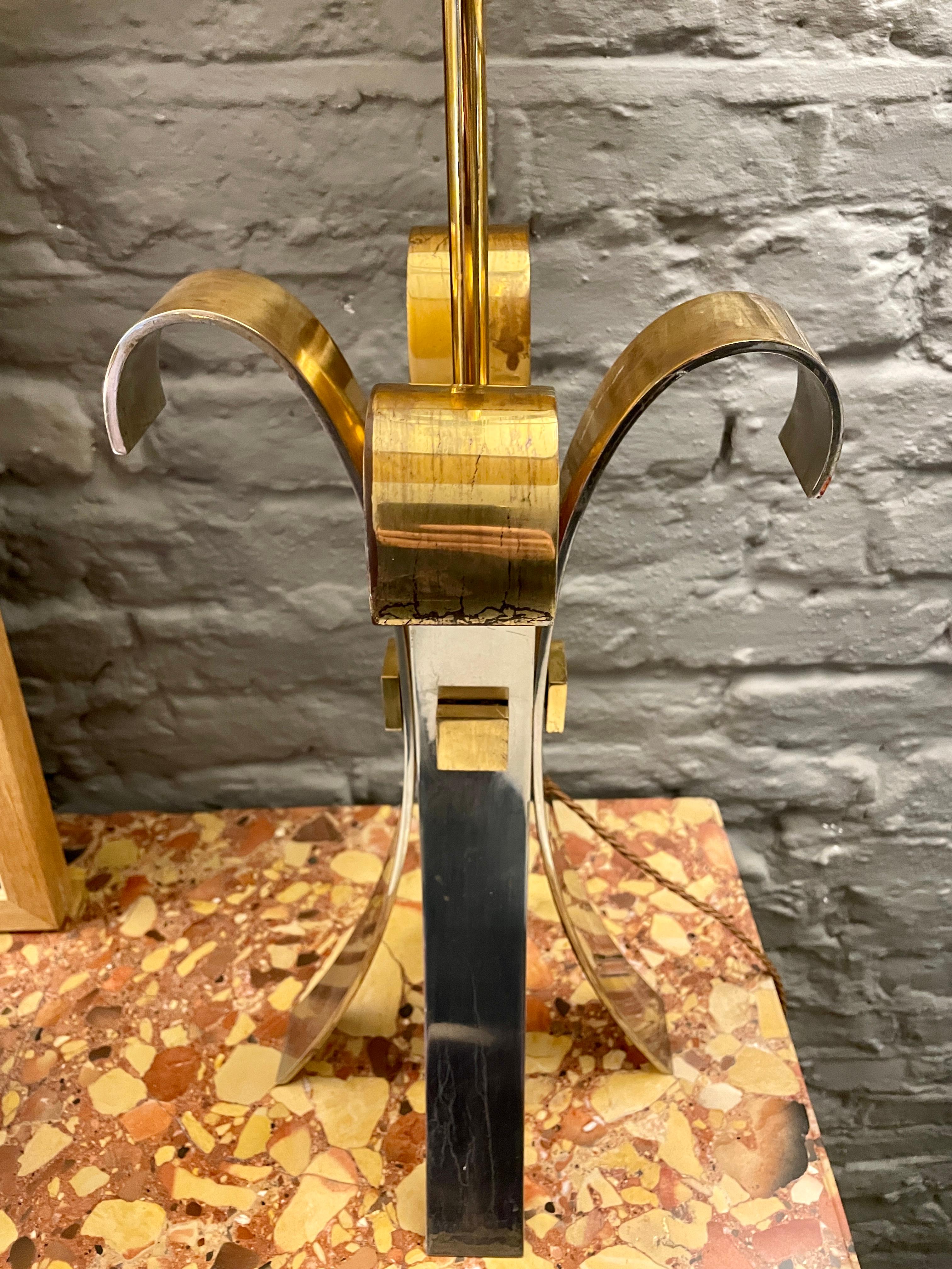 A large steel and brass table lamp by Maison Charles, The Corolle lamp from the Inox collection circa 1970. A custom order with the brass accents and brass and steel shade which is adjustable. Please refer to images for condition and reference. A