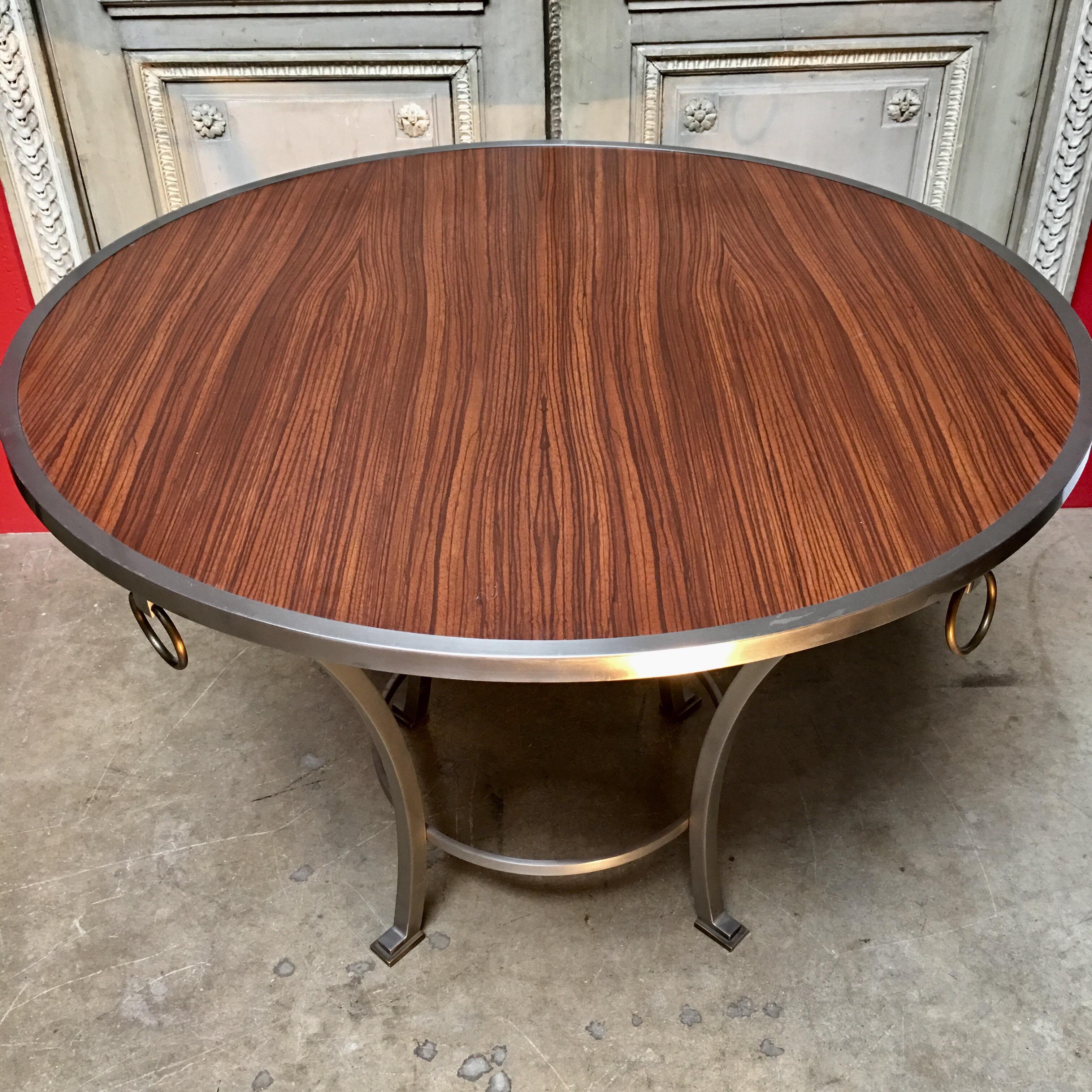 A contemporary zebra wood top table with steel frame that can be used for a dining table, center table or game table. The table has a beautiful modern look that can work with both contemporary and traditional designs. 