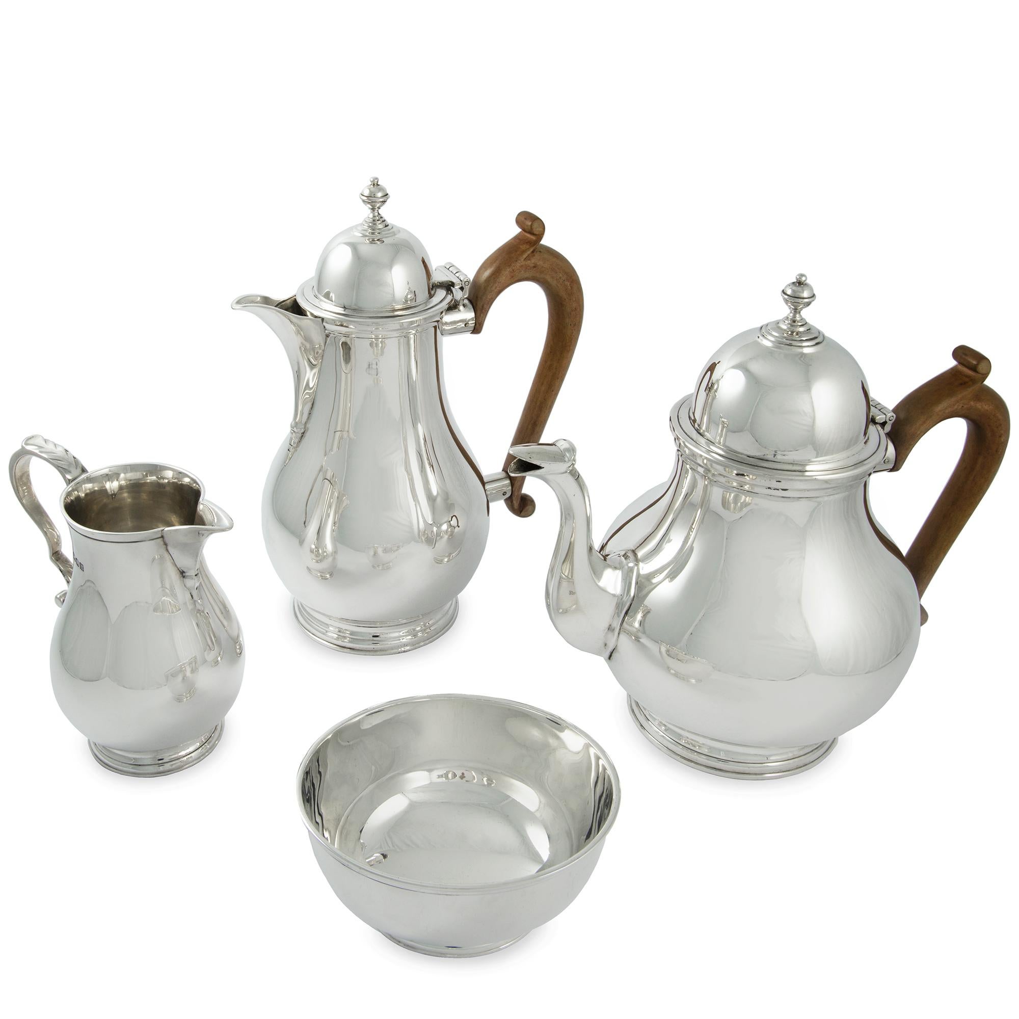 A sterling silver four-piece silver tea service, the plain design is in the early 18th century style,the two pots with scroll wooden handles, hallmarked London 1927, maker Mappin & Webb, total weight 52.5 ozs. 

Should you choose to make this