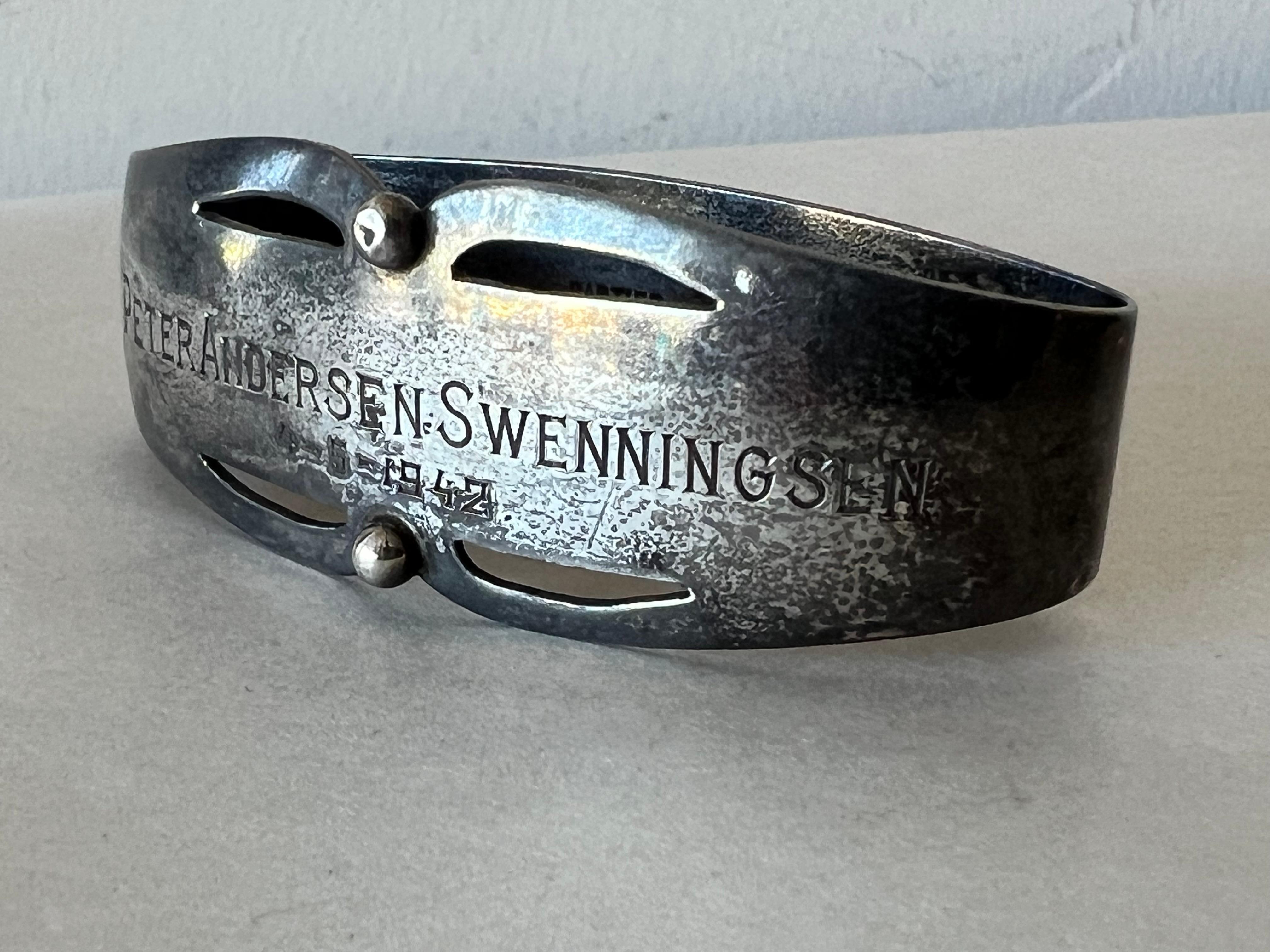 An unusual sterling silver napkin holder by Cartier, ca' 1940's in original box. Inscribed 