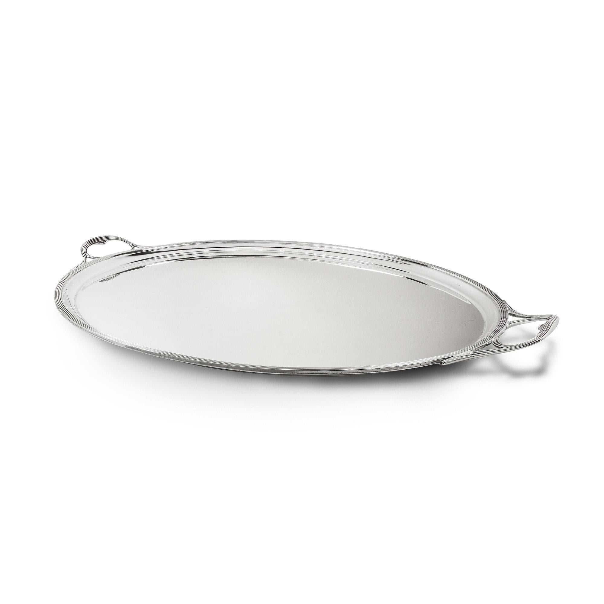 A sterling silver oval two handled tray with reeded mounts, 23