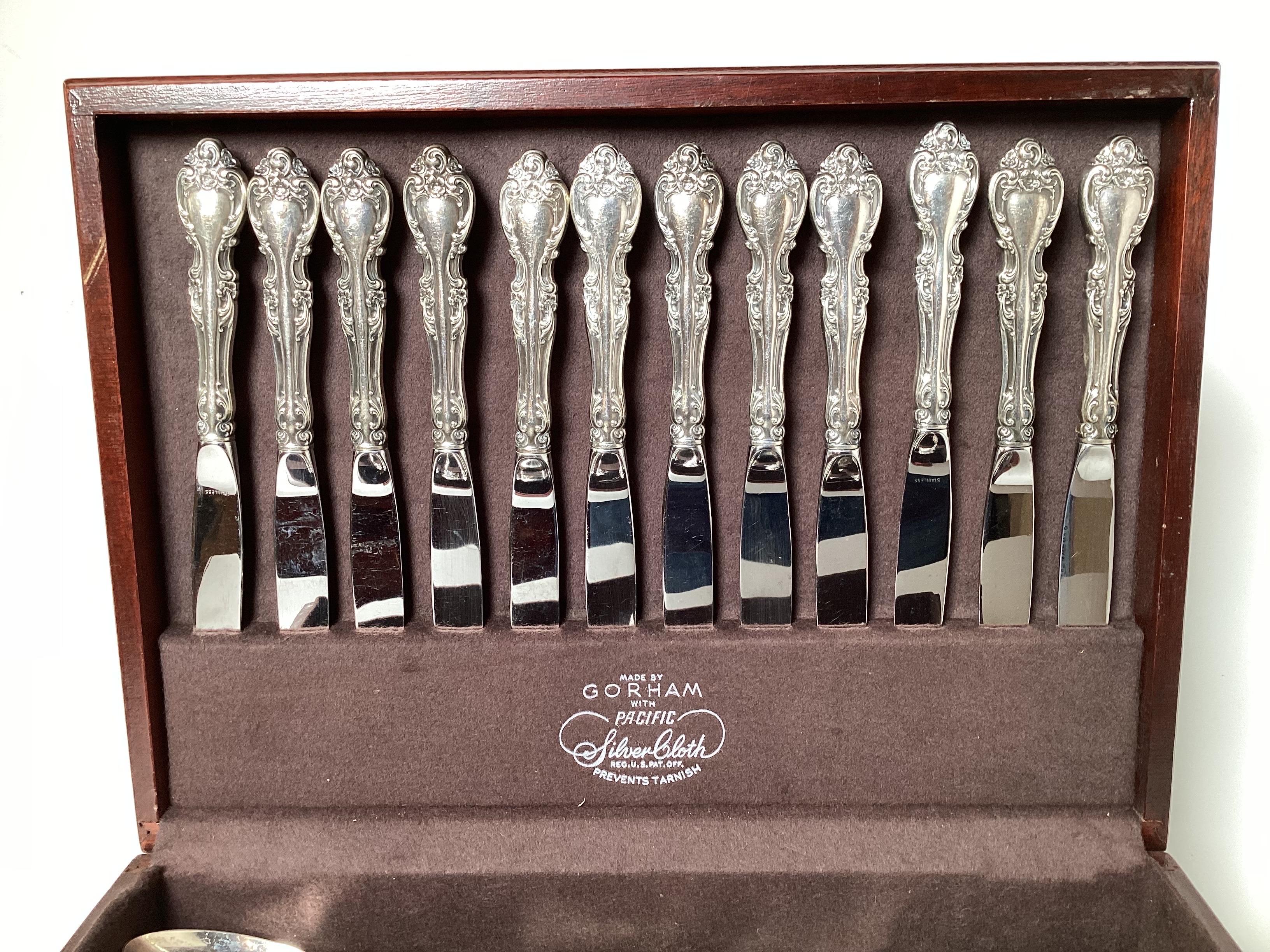 A sterling silver flatware service for 12 plus 16 serving pieces. Made by Gorham pattern, Melrose. The set consists of 12 each, dinner forks, dinner knives, salad fork, soup spoon and double teaspoons (24) along with 16 serving pieces. A total of