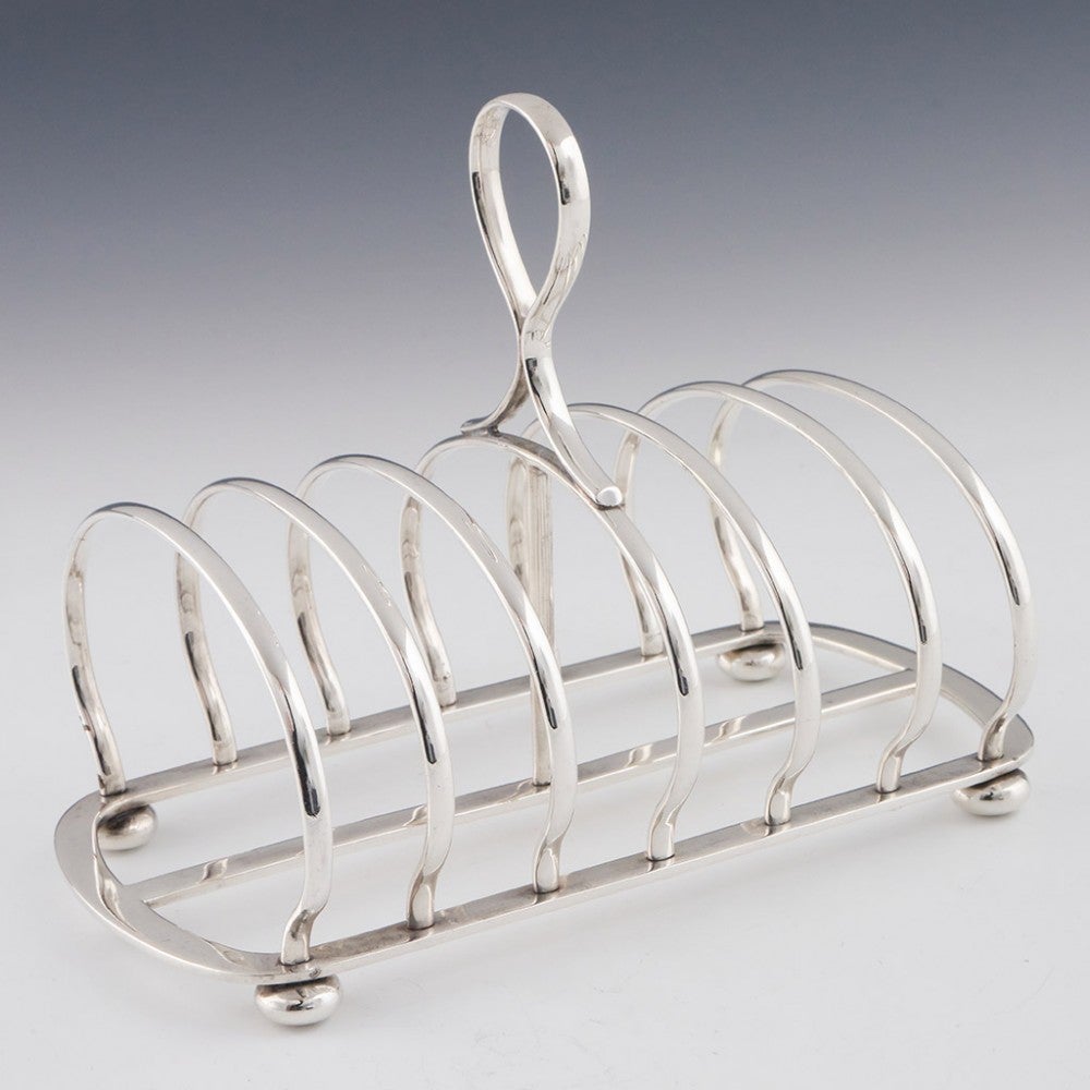 Heading : A sterling silver six division toast rack
Date : Hallmarked in Sheffield 1910 For Mappin and Webb
Period : Edward VII - George V
Origin : Sheffield England
Decoration :Omega silver wite lop handle. Silver wire divisions set on a reeded