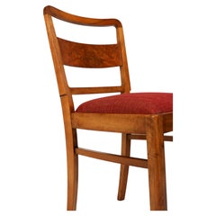 A straight Art Deco set of four walnut and burr wood chairs, with new upholstery
