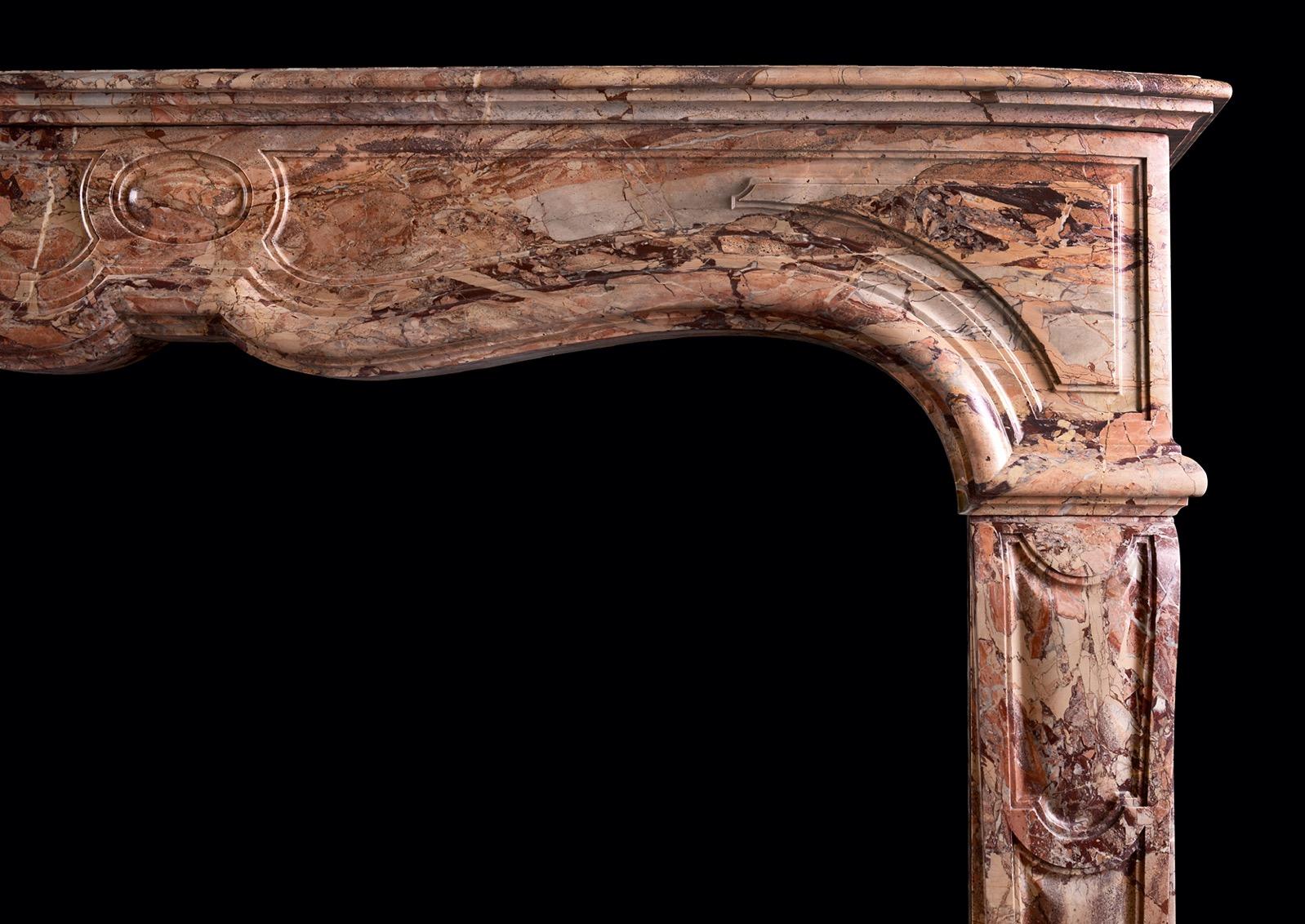 A striking Sarrancolin marble fireplace in the Louis XV style. The panelled jambs surmounted by shaped, panelled frieze and moulded shelf above. Fine quality marble. French. 

Measures: Shelf width: 1573 mm 61 