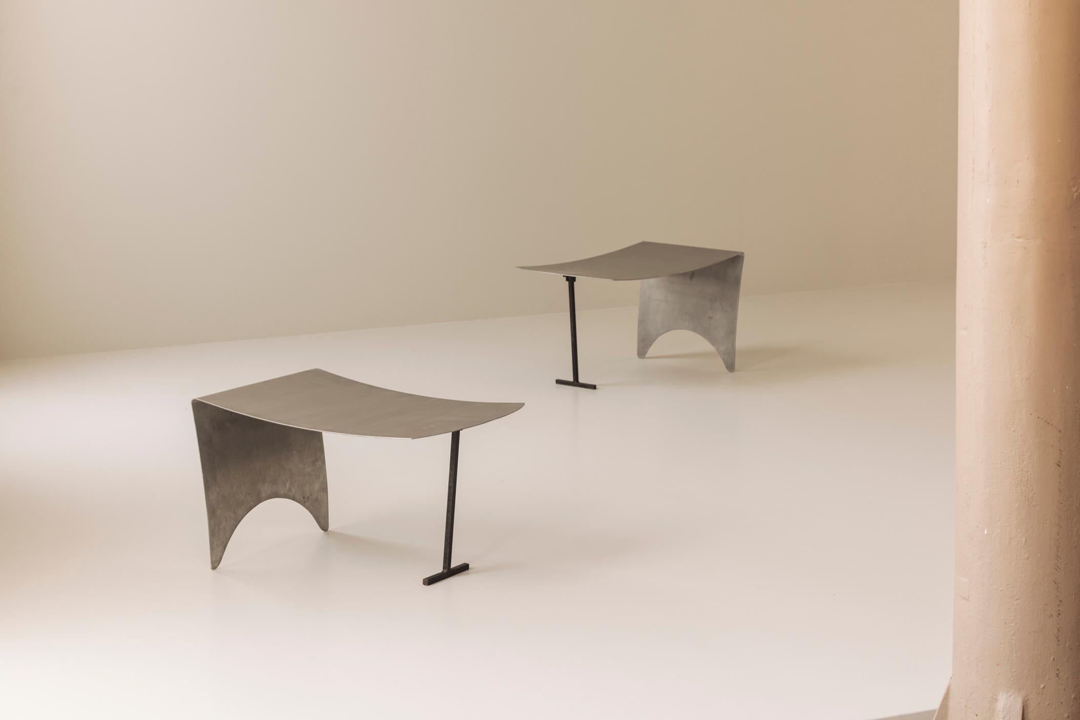 Un sorprendente set di quattro sgabelli in metallo provenienti dalla Francia, risalenti agli anni '80 e che incarnano lo spirito audace e industriale del design d'avanguardia di quel decennio. Ogni sgabello è formato da lamiere curve, sostenute da